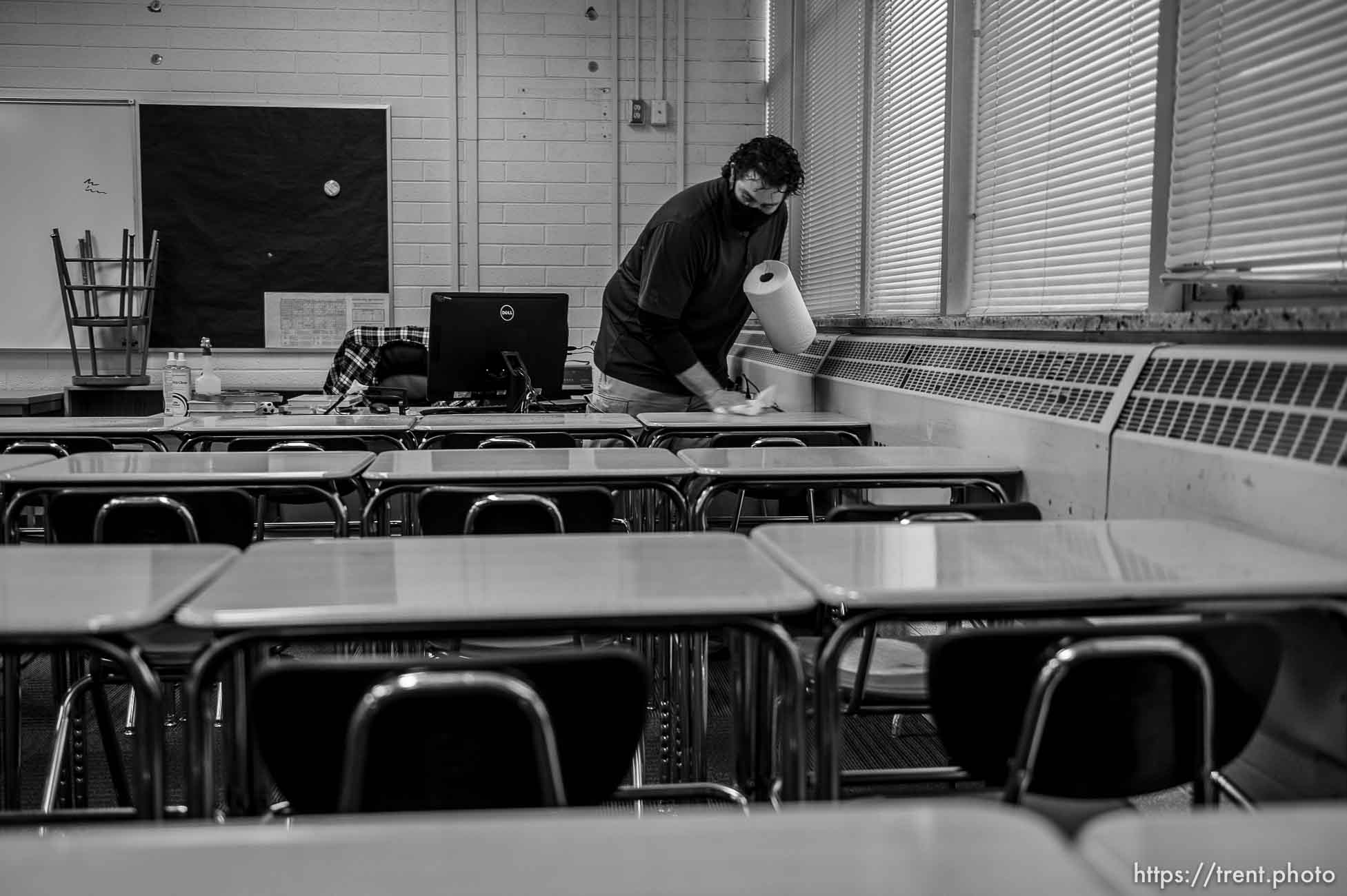 (Trent Nelson  |  The Salt Lake Tribune) Science teacher Robert Campos wipes down desks in his classroom as students return to Highland High School in Salt Lake City on Monday, Feb. 8, 2021.