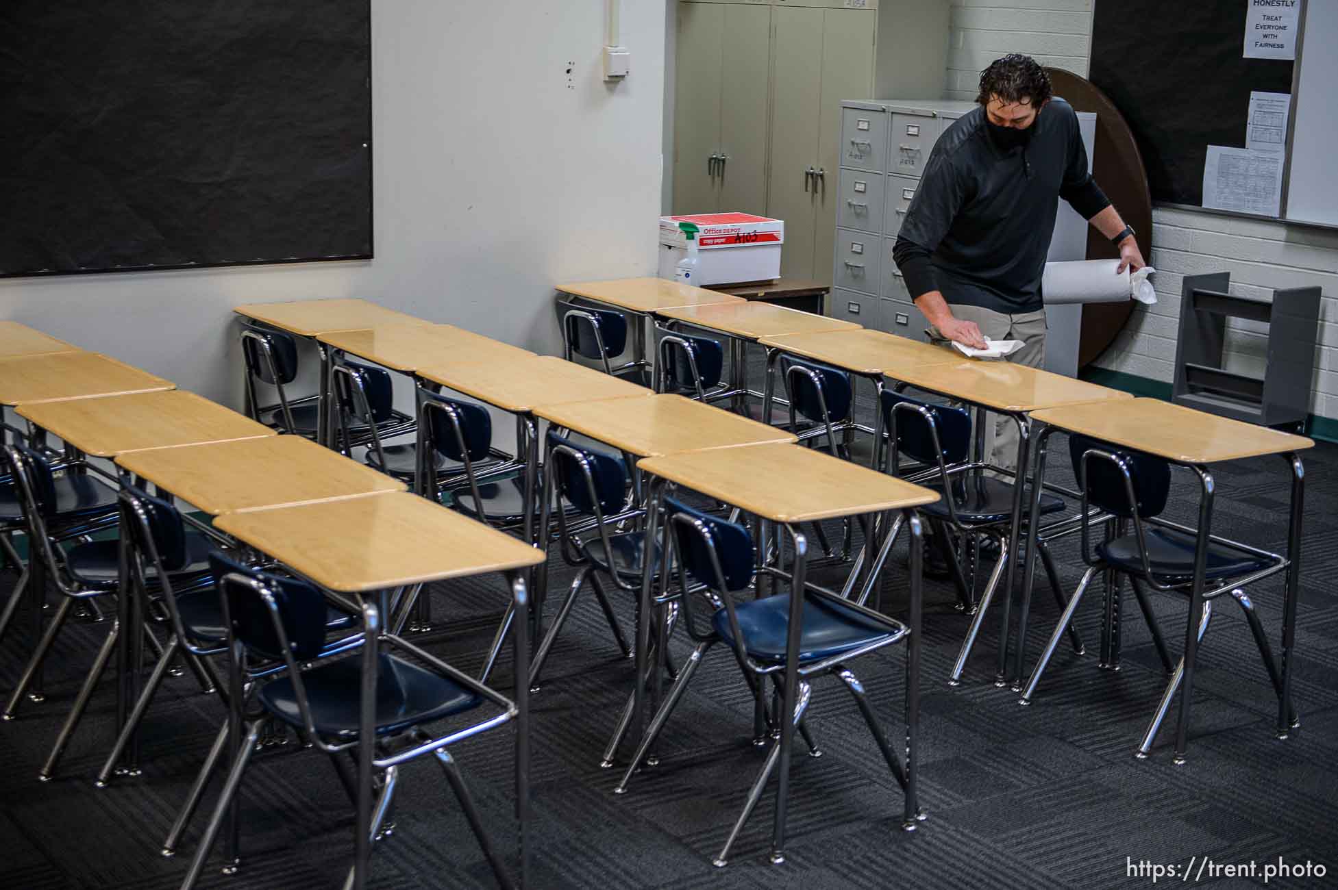 (Trent Nelson  |  The Salt Lake Tribune) Science teacher Robert Campos wipes down desks in his classroom as students return to Highland High School in Salt Lake City on Monday, Feb. 8, 2021.