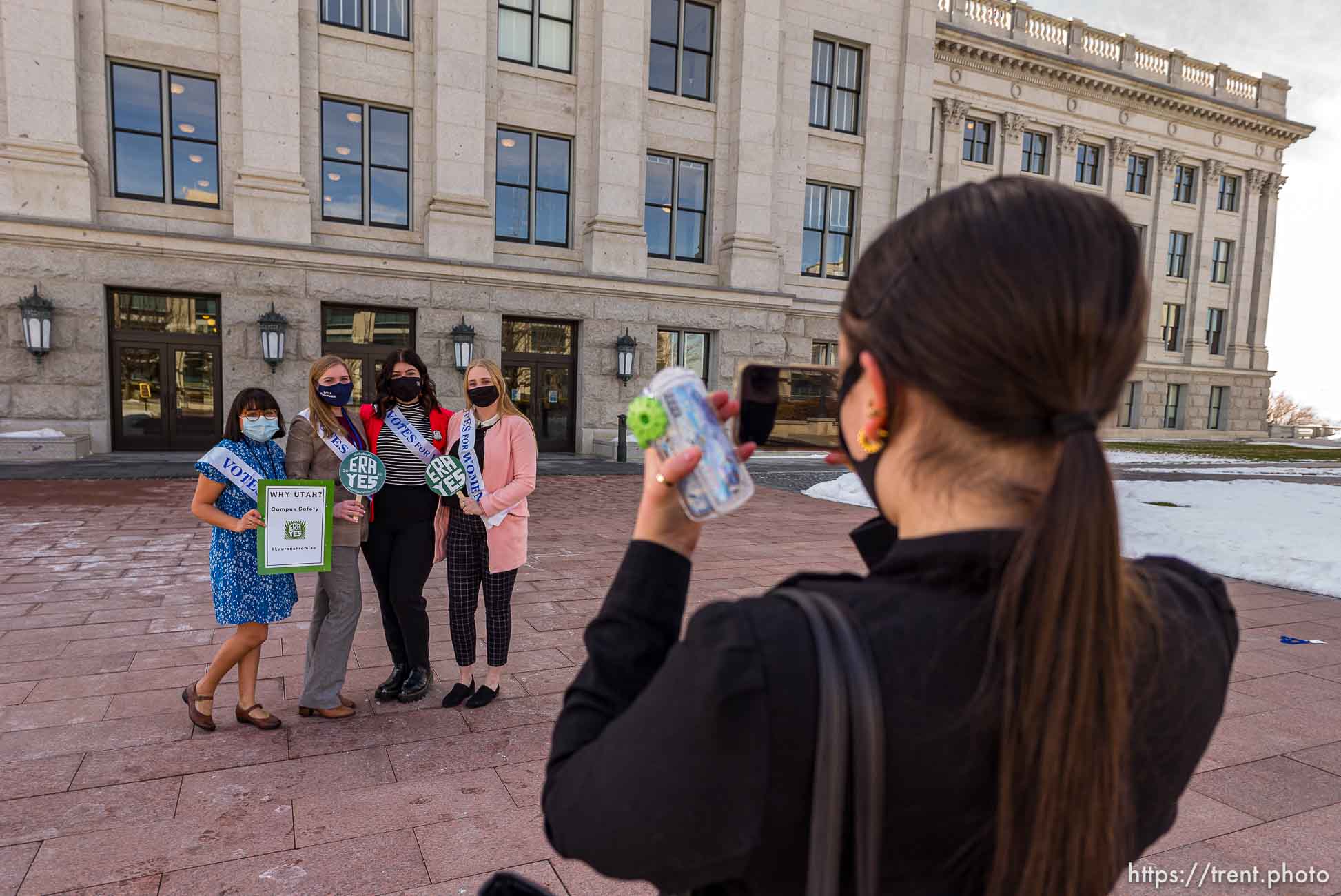 (Trent Nelson  |  The Salt Lake Tribune) McKenna Pastorik, right, takes a photograph of Gloria Aquino, Hannah Tew, Jess Wojciechowski, and Katie Whitehead as people gather in support of the Equal Rights Amendment (ERA) in front of a statue of Martha Hughes Cannon at the state Capitol in Salt Lake City on Tuesday, March 2, 2021.