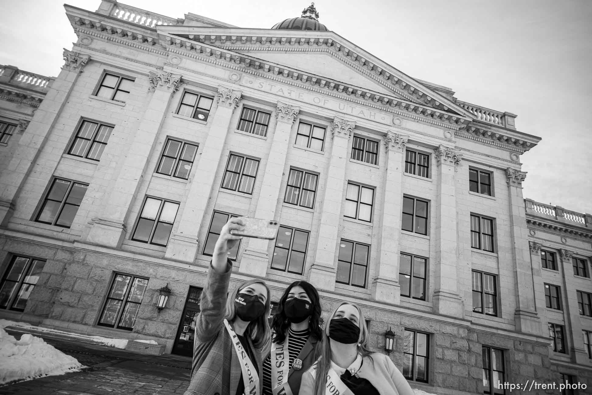 (Trent Nelson  |  The Salt Lake Tribune) Hannah Tew, Jess Wojciechowski, and Katie Whitehead take a selfie as people gather in support of the Equal Rights Amendment (ERA) in front of a statue of Martha Hughes Cannon at the state Capitol in Salt Lake City on Tuesday, March 2, 2021.