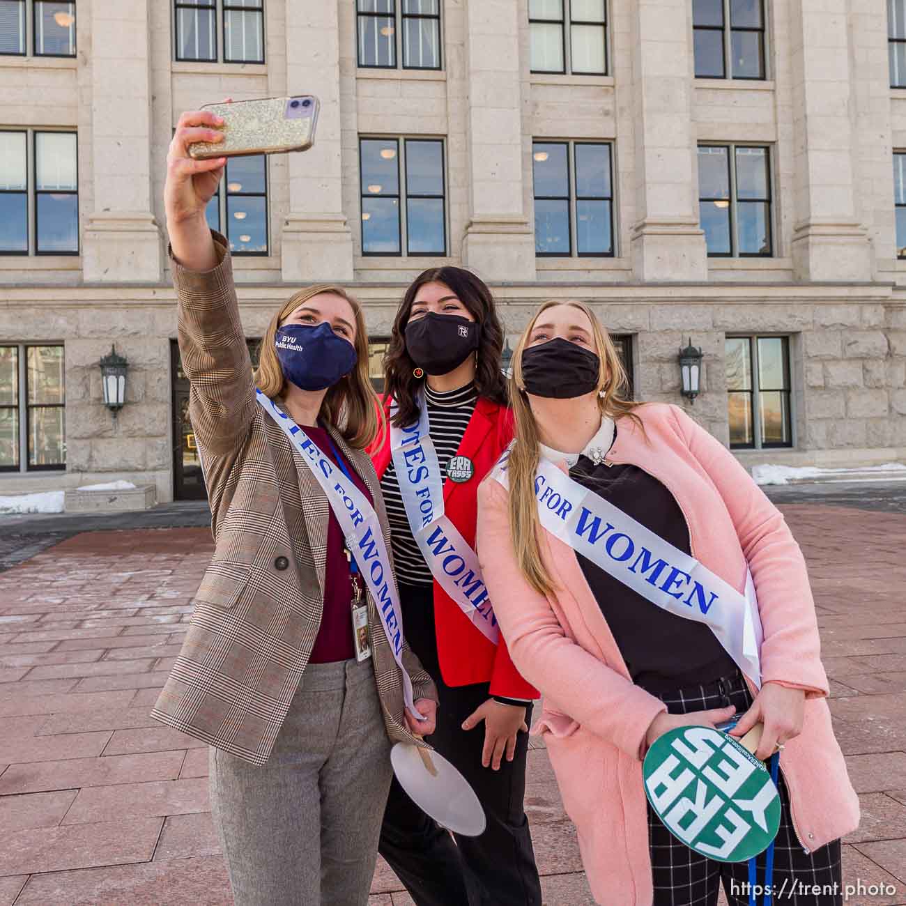 (Trent Nelson  |  The Salt Lake Tribune) Hannah Tew, Jess Wojciechowski, and Katie Whitehead take a selfie as people gather in support of the Equal Rights Amendment (ERA) in front of a statue of Martha Hughes Cannon at the state Capitol in Salt Lake City on Tuesday, March 2, 2021.