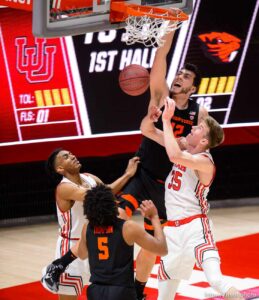 (Trent Nelson  |  The Salt Lake Tribune) Oregon State Beavers center Roman Silva (12) dunks the ball ahead of Utah Utes center Branden Carlson (35) as Utah hosts Oregon State, NCAA basketball in Salt Lake City on Wednesday, March 3, 2021.