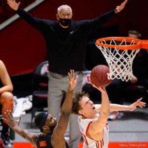 (Trent Nelson  |  The Salt Lake Tribune) Utah Utes forward Mikael Jantunen (20) scores ahead of Oregon State Beavers forward Rodrigue Andela (34) as Utah hosts Oregon State, NCAA basketball in Salt Lake City on Wednesday, March 3, 2021.