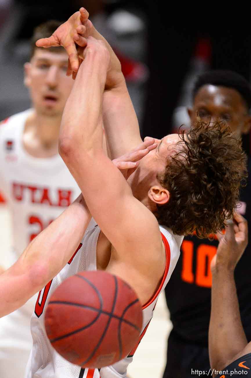 (Trent Nelson  |  The Salt Lake Tribune) Utah Utes forward Mikael Jantunen (20) takes a hand to the face from Oregon State Beavers guard Zach Reichle (11) as Utah hosts Oregon State, NCAA basketball in Salt Lake City on Wednesday, March 3, 2021.