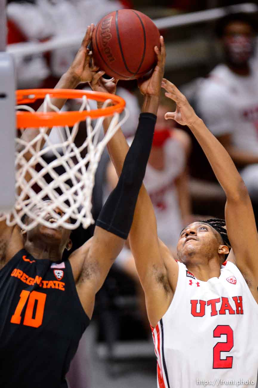 (Trent Nelson  |  The Salt Lake Tribune) Oregon State Beavers forward Warith Alatishe (10) and Utah Utes guard Ian Martinez (2) reach for the ball as Utah hosts Oregon State, NCAA basketball in Salt Lake City on Wednesday, March 3, 2021.