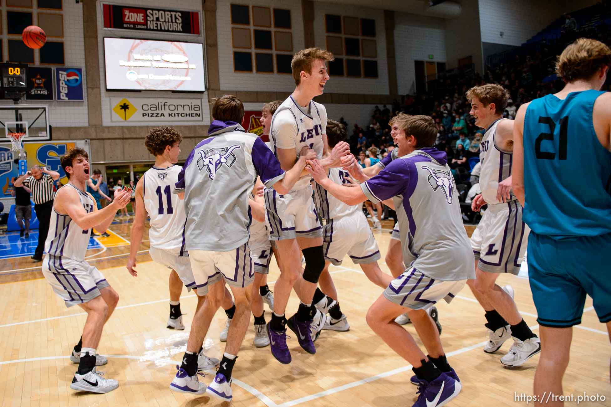 (Trent Nelson  |  The Salt Lake Tribune) Lehi players celebrate a win over Farmington High School in the 5A boys basketball state championship game, in Taylorsville on Saturday, March 6, 2021.