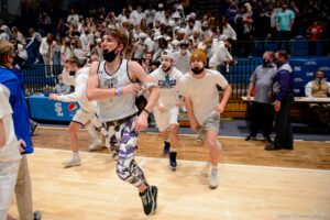 (Trent Nelson  |  The Salt Lake Tribune) Lehi fans rush the court to celebrate a win over Farmington High School in the 5A boys basketball state championship game, in Taylorsville on Saturday, March 6, 2021.