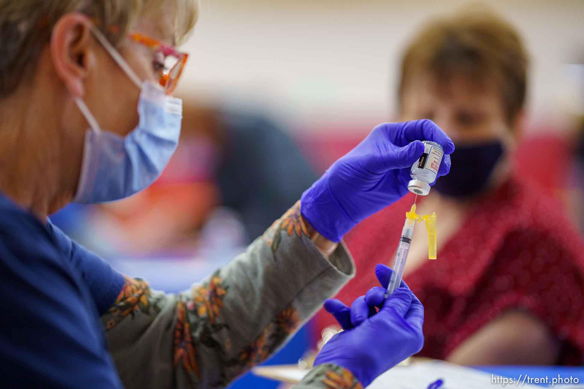 (Trent Nelson  |  The Salt Lake Tribune) Marilyn Gertsch  administers a shot as teachers and staff of the Canyons School District received their second shots of the Moderna vaccine at Mount Jordan Middle School in Sandy on Thursday, March 11, 2021.