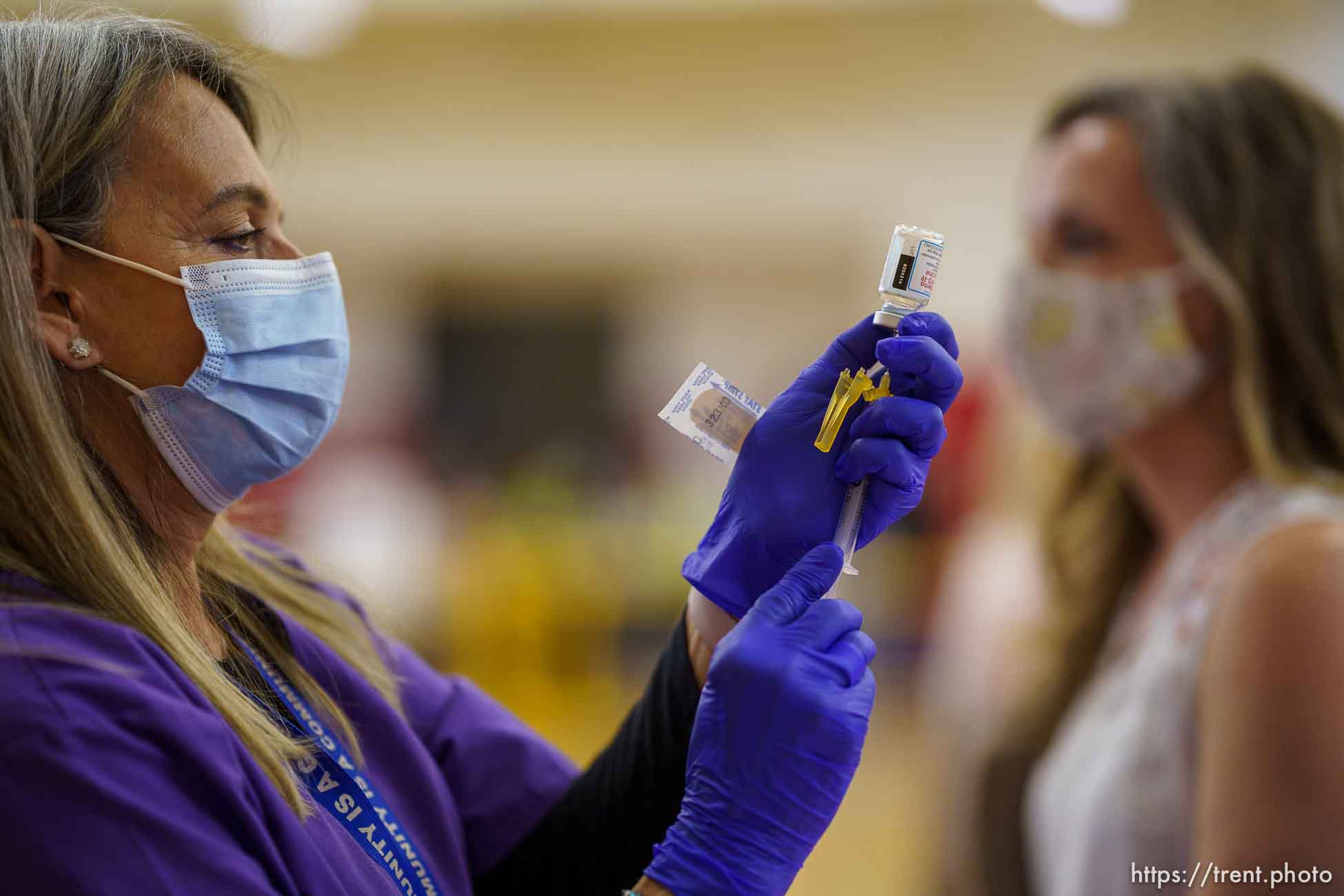 (Trent Nelson  |  The Salt Lake Tribune) Lacie Odom vaccinates Ronnie Mulqueen as teachers and staff of the Canyons School District received their second shots of the Moderna vaccine at Mount Jordan Middle School in Sandy on Thursday, March 11, 2021.