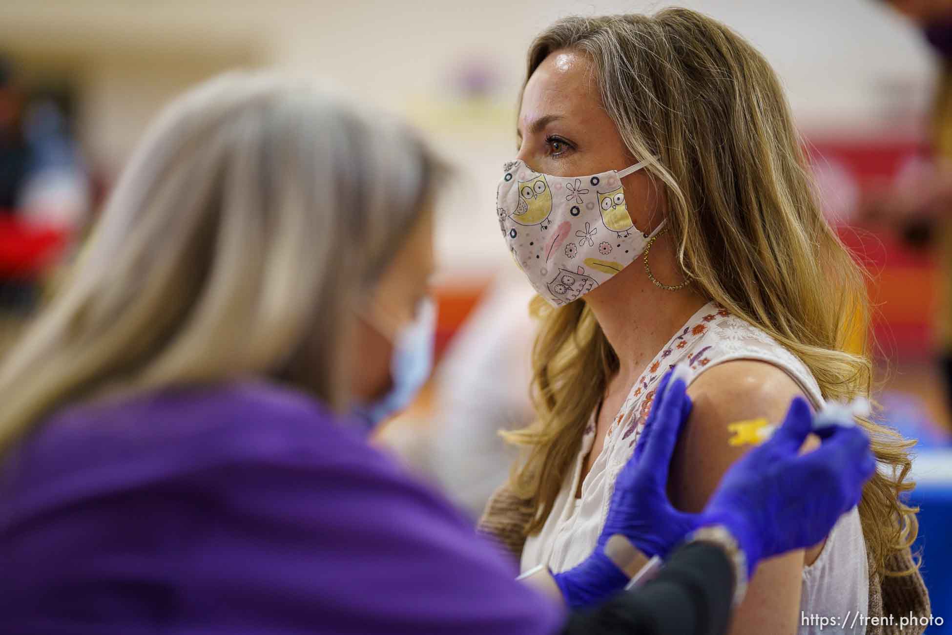 (Trent Nelson  |  The Salt Lake Tribune) Lacie Odom vaccinates Ronnie Mulqueen as teachers and staff of the Canyons School District received their second shots of the Moderna vaccine at Mount Jordan Middle School in Sandy on Thursday, March 11, 2021.