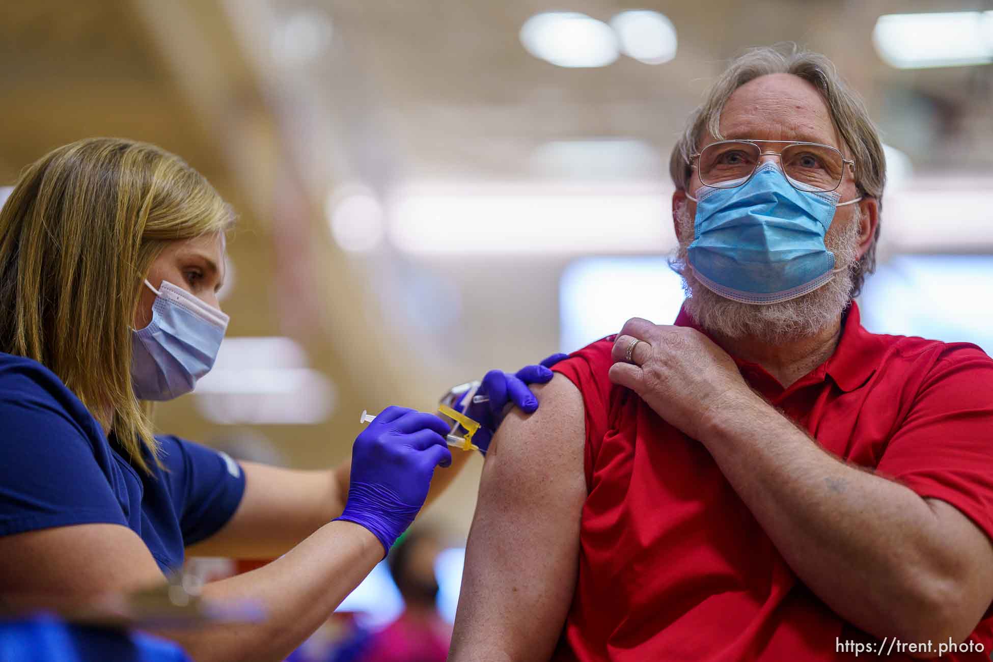 (Trent Nelson  |  The Salt Lake Tribune) Marielle Nielsen  vaccinates James Shell as teachers and staff of the Canyons School District received their second shots of the Moderna vaccine at Mount Jordan Middle School in Sandy on Thursday, March 11, 2021.