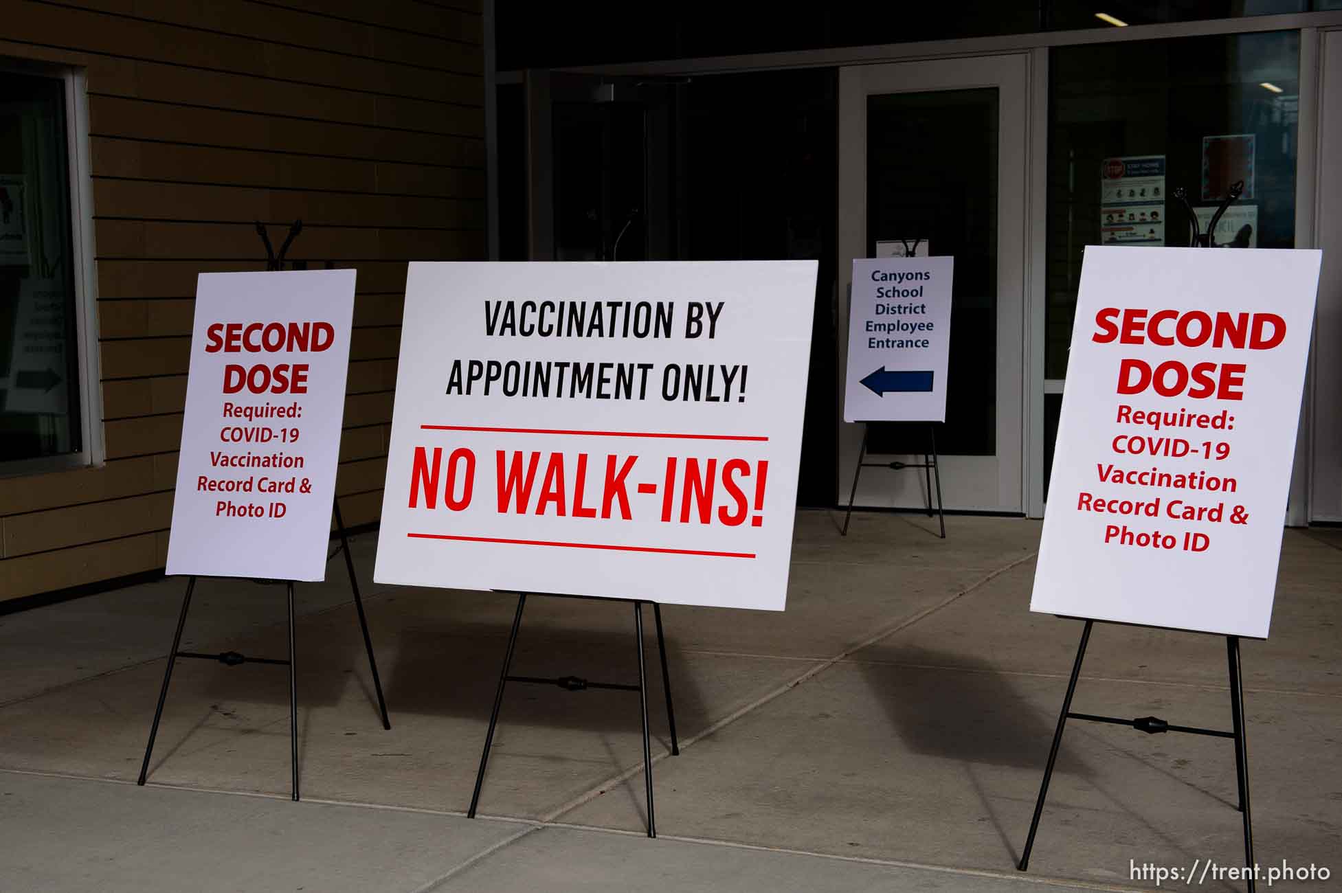 (Trent Nelson  |  The Salt Lake Tribune) Signs out front as teachers and staff of the Canyons School District received their second shots of the Moderna vaccine at Mount Jordan Middle School in Sandy on Thursday, March 11, 2021.