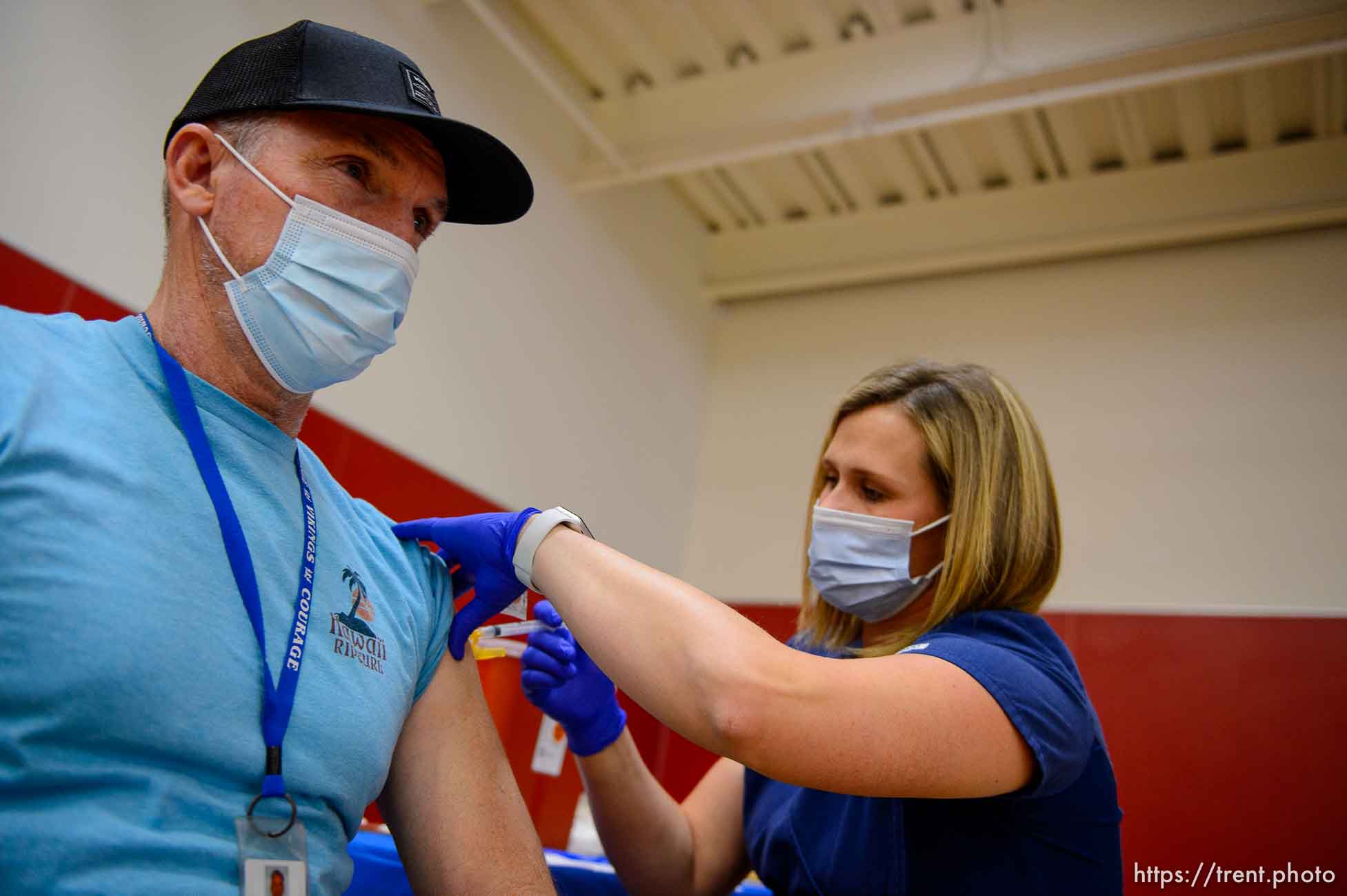 (Trent Nelson  |  The Salt Lake Tribune) Rhodes Baker is vaccinated by Marielle Nielsen as teachers and staff of the Canyons School District received their second shots of the Moderna vaccine at Mount Jordan Middle School in Sandy on Thursday, March 11, 2021.