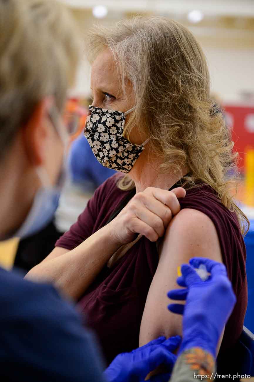 (Trent Nelson  |  The Salt Lake Tribune) Rebecca Lee receives a vaccination from Marilyn Gertsch as teachers and staff of the Canyons School District received their second shots of the Moderna vaccine at Mount Jordan Middle School in Sandy on Thursday, March 11, 2021.