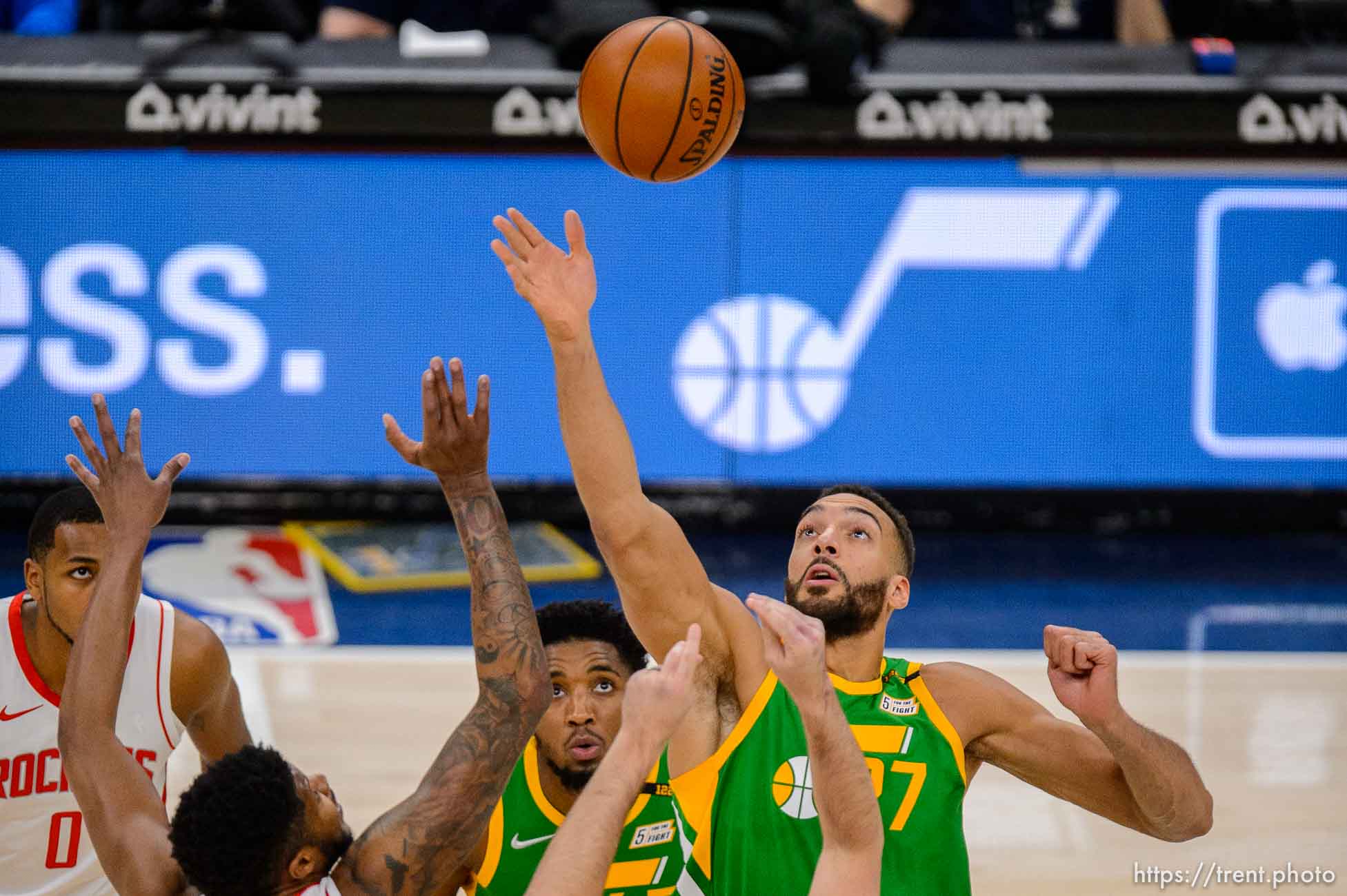 (Trent Nelson  |  The Salt Lake Tribune) Utah Jazz center Rudy Gobert (27) reaches up for the ball on the opening tip as the Utah Jazz host the Houston Rockets, NBA basketball in Salt Lake City on Friday, March 12, 2021. At center is Utah Jazz guard Donovan Mitchell (45), and left is Houston Rockets center Justin Patton (26).