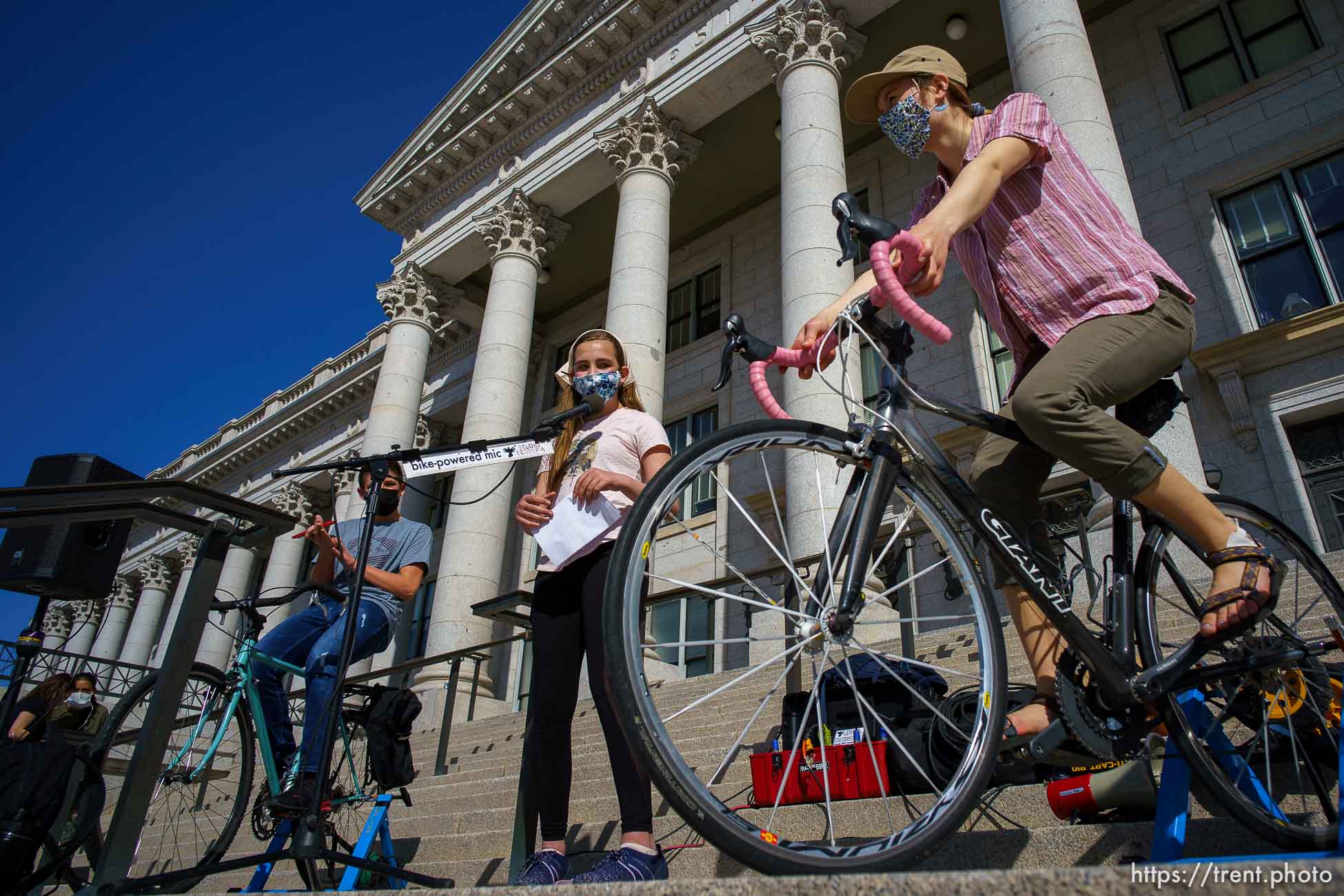 (Trent Nelson  |  The Salt Lake Tribune) Melanie Van Hook speaks on a bike-powered microphone as students gather at the state Capitol in Salt Lake Cityto protest inaction on the climate crisis on Friday, March 19, 2021.