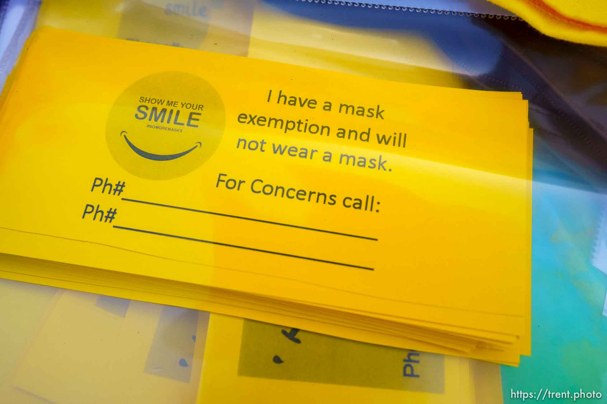 (Trent Nelson  |  The Salt Lake Tribune) Mask exemption cards at a rally outside of the Granite School District offices in South Salt Lake on Saturday, April 10, 2021. Rallies were announced for all Utah school district offices by a coalition of groups opposed to mask mandates.