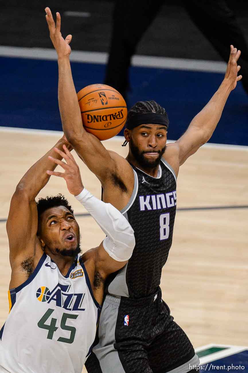 (Trent Nelson  |  The Salt Lake Tribune) Utah Jazz guard Donovan Mitchell (45) is fouled by Sacramento Kings forward Maurice Harkless (8) as the Utah Jazz host the Sacramento Kings, NBA basketball in Salt Lake City on Saturday, April 10, 2021.