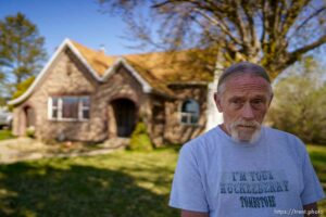 (Trent Nelson  |  The Salt Lake Tribune) Dean Andreason stands in front of his Syracuse home on Tuesday, April 13, 2021.  UDOT is attempting to take his home as part of a new highway project.