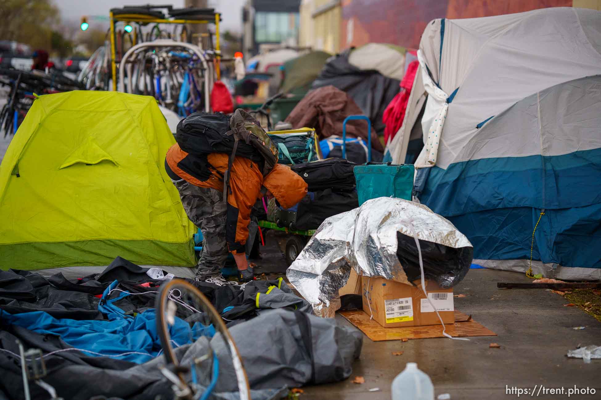 (Trent Nelson  |  The Salt Lake Tribune) A person organizes their belongings as Salt Lake County conducts a camp cleanup at the Fleet Block Murals in Salt Lake City on Wednesday, April 14, 2021.