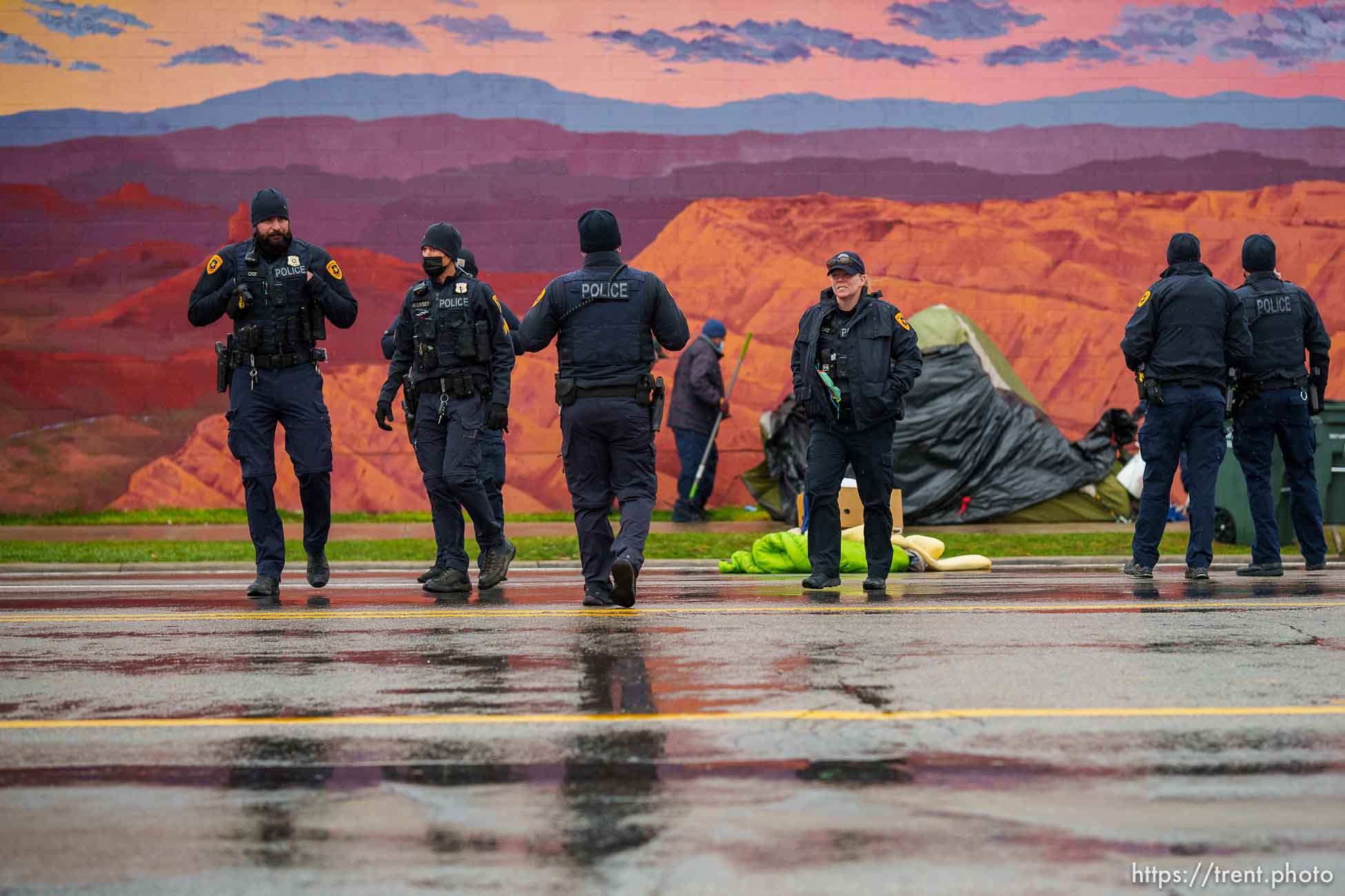 (Trent Nelson  |  The Salt Lake Tribune) Police stand by as Salt Lake County conducts a camp cleanup at the Fleet Block Murals in Salt Lake City on Wednesday, April 14, 2021.