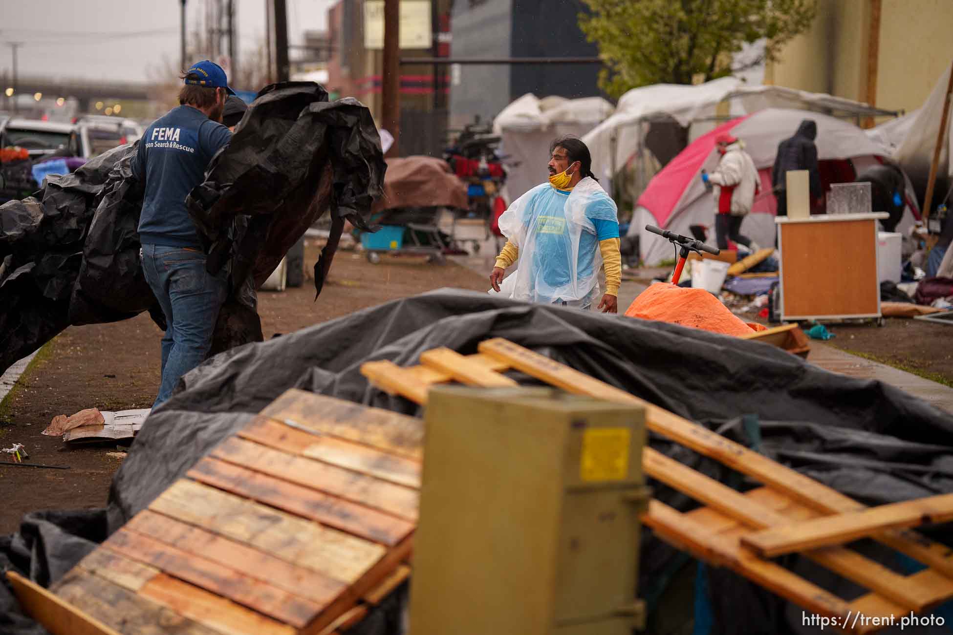 (Trent Nelson  |  The Salt Lake Tribune) Carl Moore helps people move their belongings as Salt Lake County conducts a camp cleanup at the Fleet Block Murals in Salt Lake City on Wednesday, April 14, 2021.