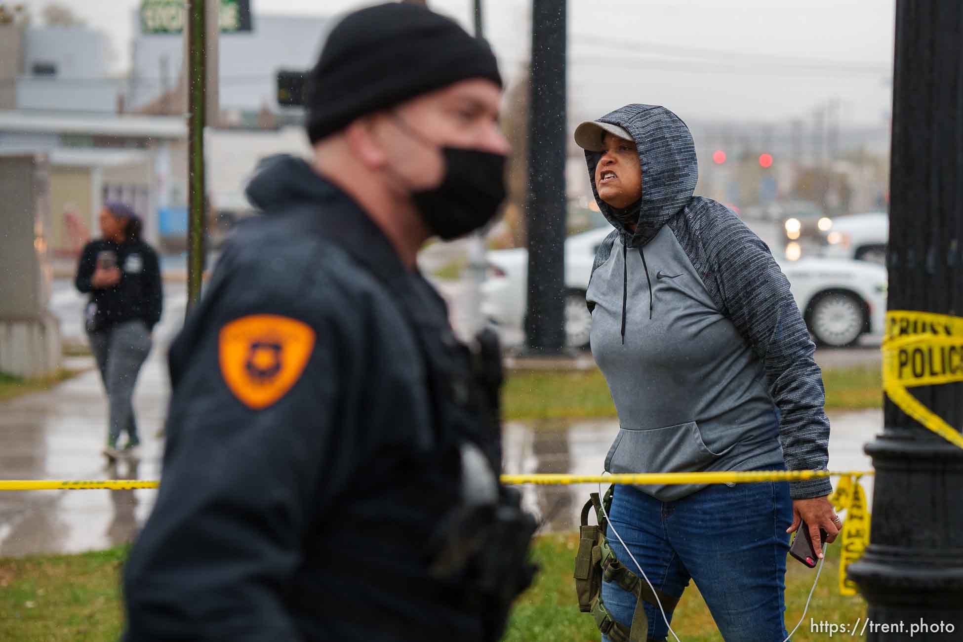 (Trent Nelson  |  The Salt Lake Tribune) Lex Scott and Rae Duckworth, and police, as Salt Lake County conducts a camp cleanup at the Fleet Block Murals in Salt Lake City on Wednesday, April 14, 2021.