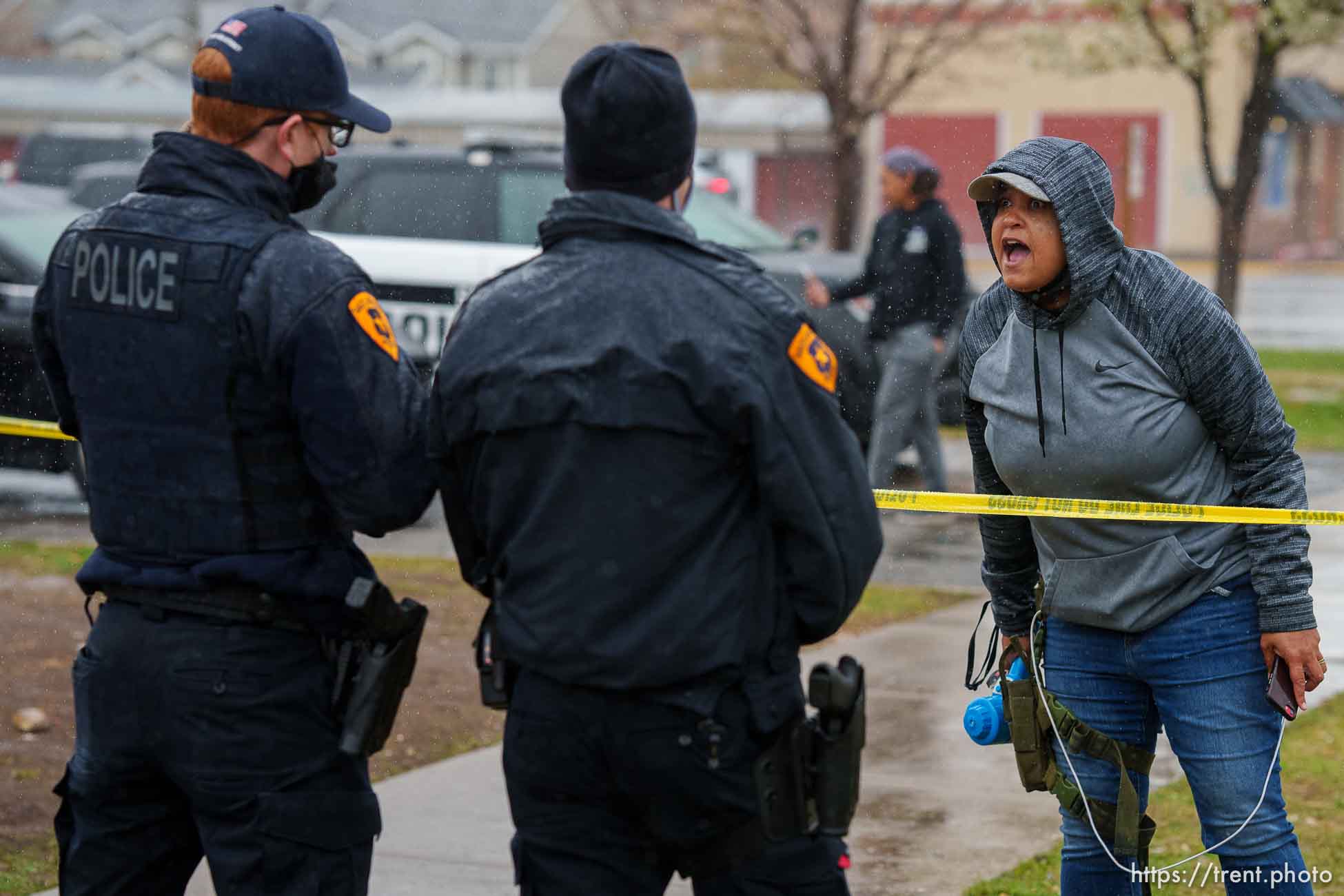 (Trent Nelson  |  The Salt Lake Tribune) Lex Scott and Rae Duckworth, and police, as Salt Lake County conducts a camp cleanup at the Fleet Block Murals in Salt Lake City on Wednesday, April 14, 2021.