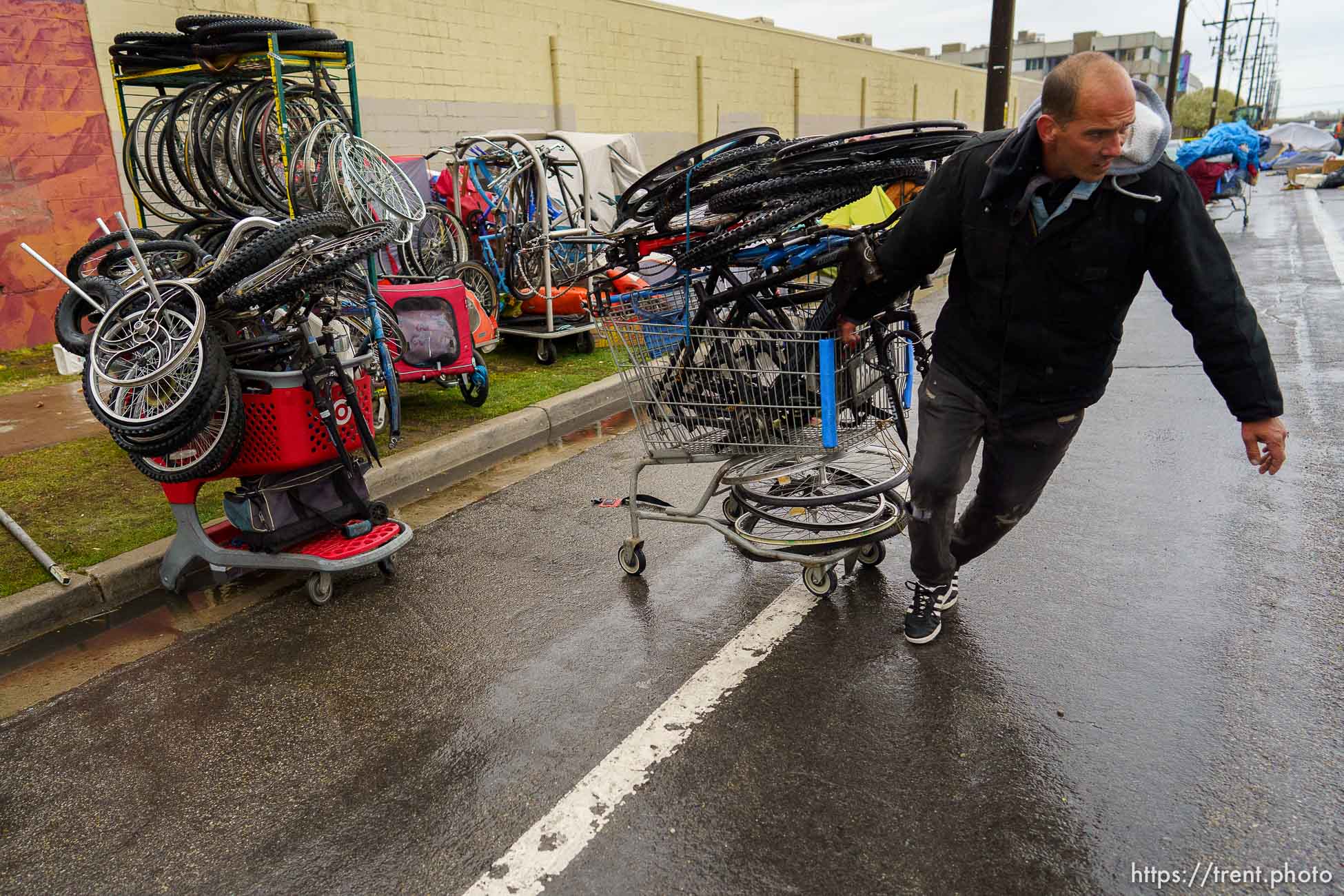 (Trent Nelson  |  The Salt Lake Tribune) Drew Burn helps others organize their belongings as Salt Lake County conducts a camp cleanup at the Fleet Block Murals in Salt Lake City on Wednesday, April 14, 2021.