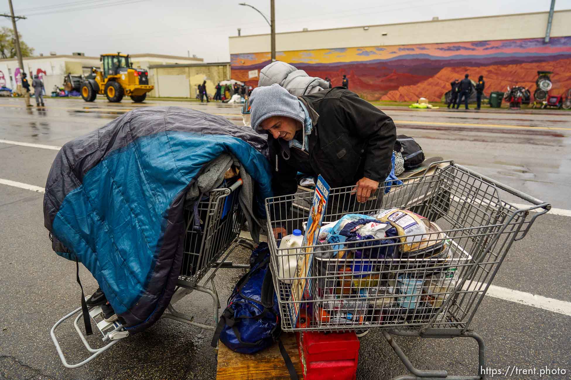 (Trent Nelson  |  The Salt Lake Tribune) Drew Burn moves his belongings as Salt Lake County conducts a camp cleanup at the Fleet Block Murals in Salt Lake City on Wednesday, April 14, 2021.