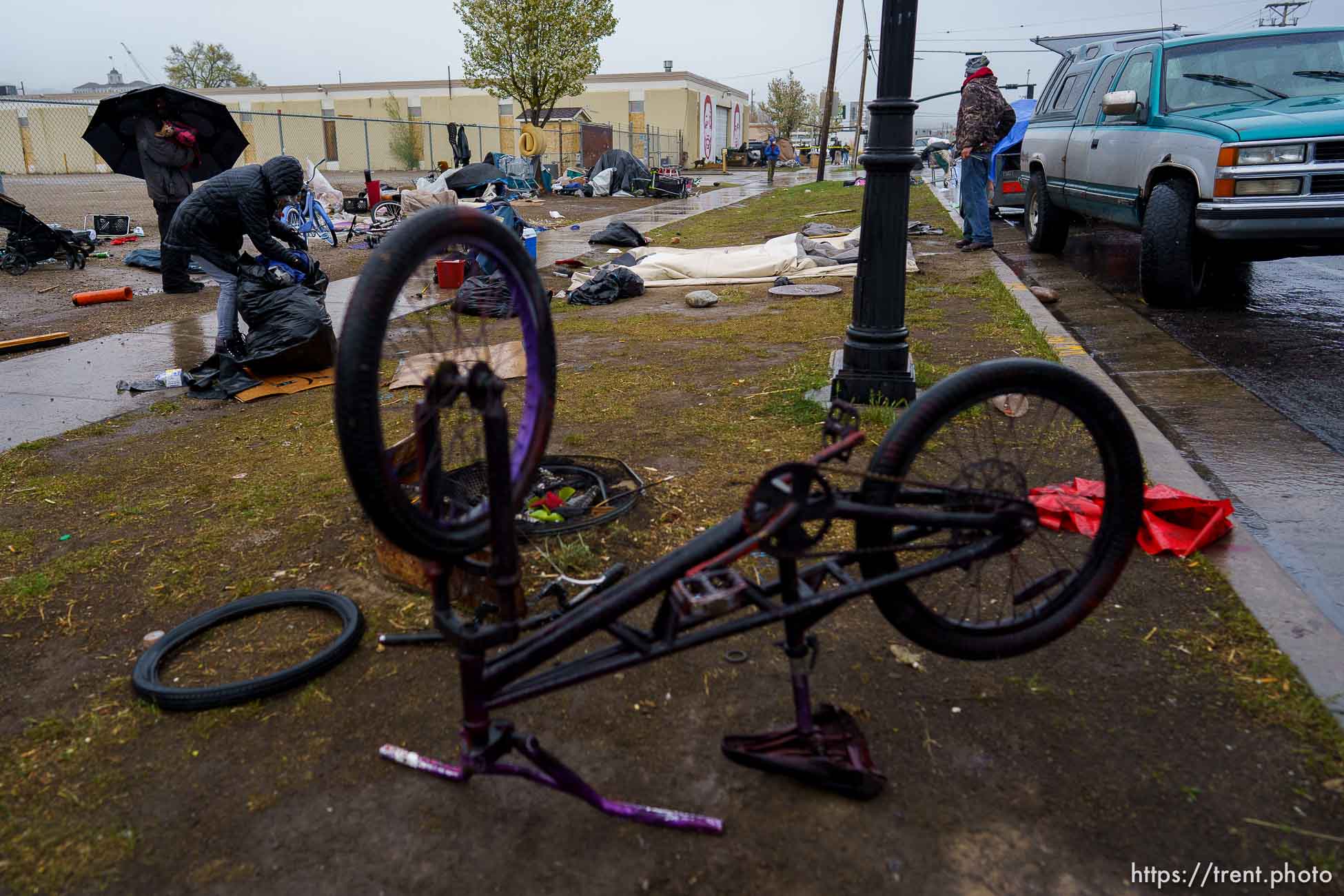 (Trent Nelson  |  The Salt Lake Tribune) People sort their belongings as Salt Lake County conducts a camp cleanup at the Fleet Block Murals in Salt Lake City on Wednesday, April 14, 2021.