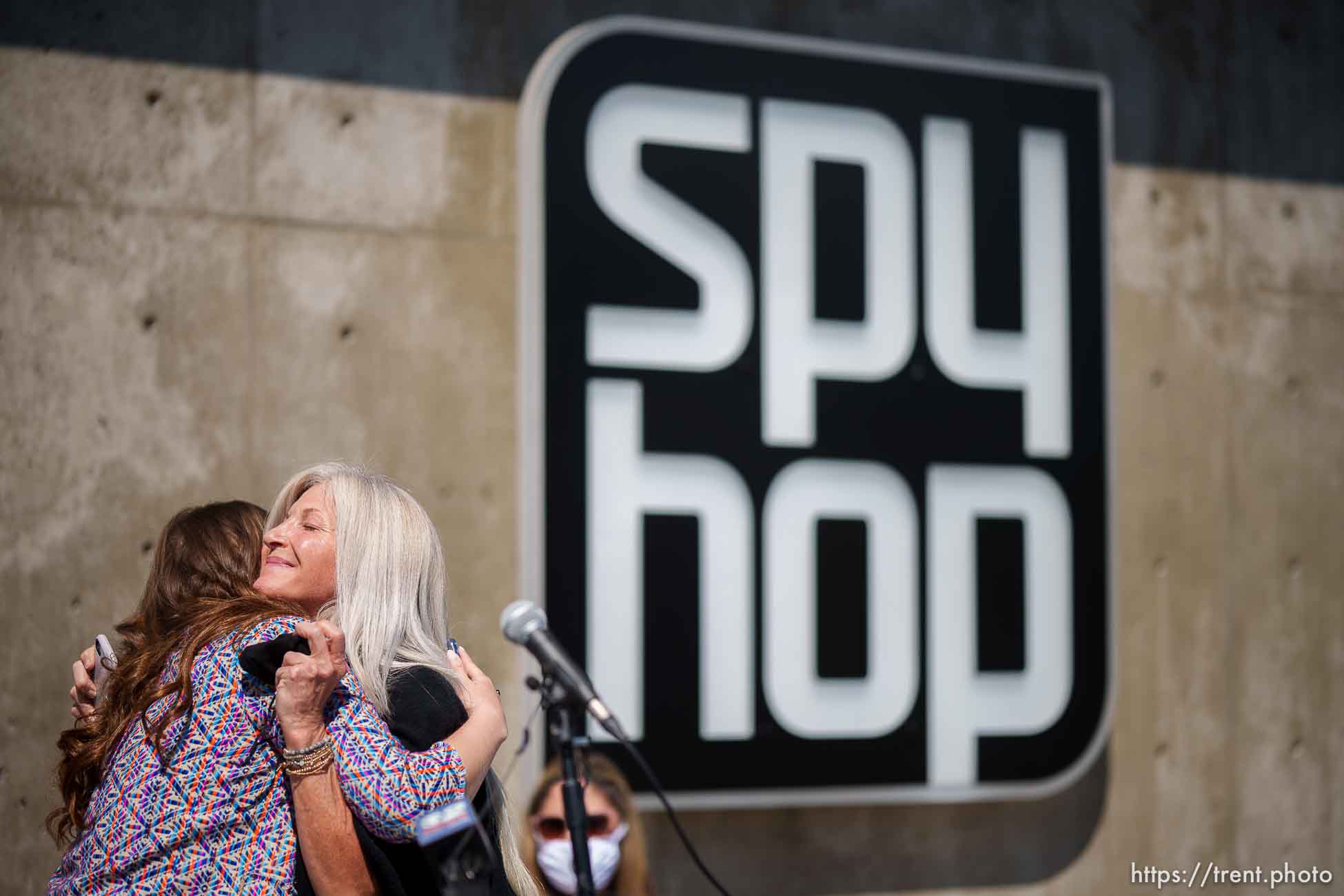 (Trent Nelson  |  The Salt Lake Tribune) Missy Greis embraces Heather Kahlert during a dedication ceremony of Spy Hop’s new headquarters in the Central Ninth neighborhood of Salt Lake City on Wednesday, April 28, 2021.