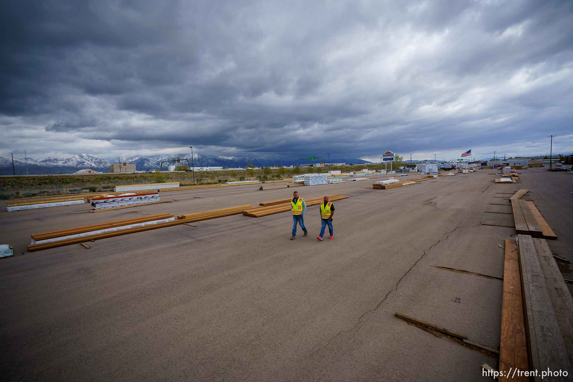 (Trent Nelson  |  The Salt Lake Tribune) Jason Butterfield and Jason Barnett walk through the sparse yard a Sunpro in Salt Lake City on Tuesday, April 27, 2021. A national shortage of lumber is stalling and driving up costs on big construction projects and small home improvements alike in Utah.