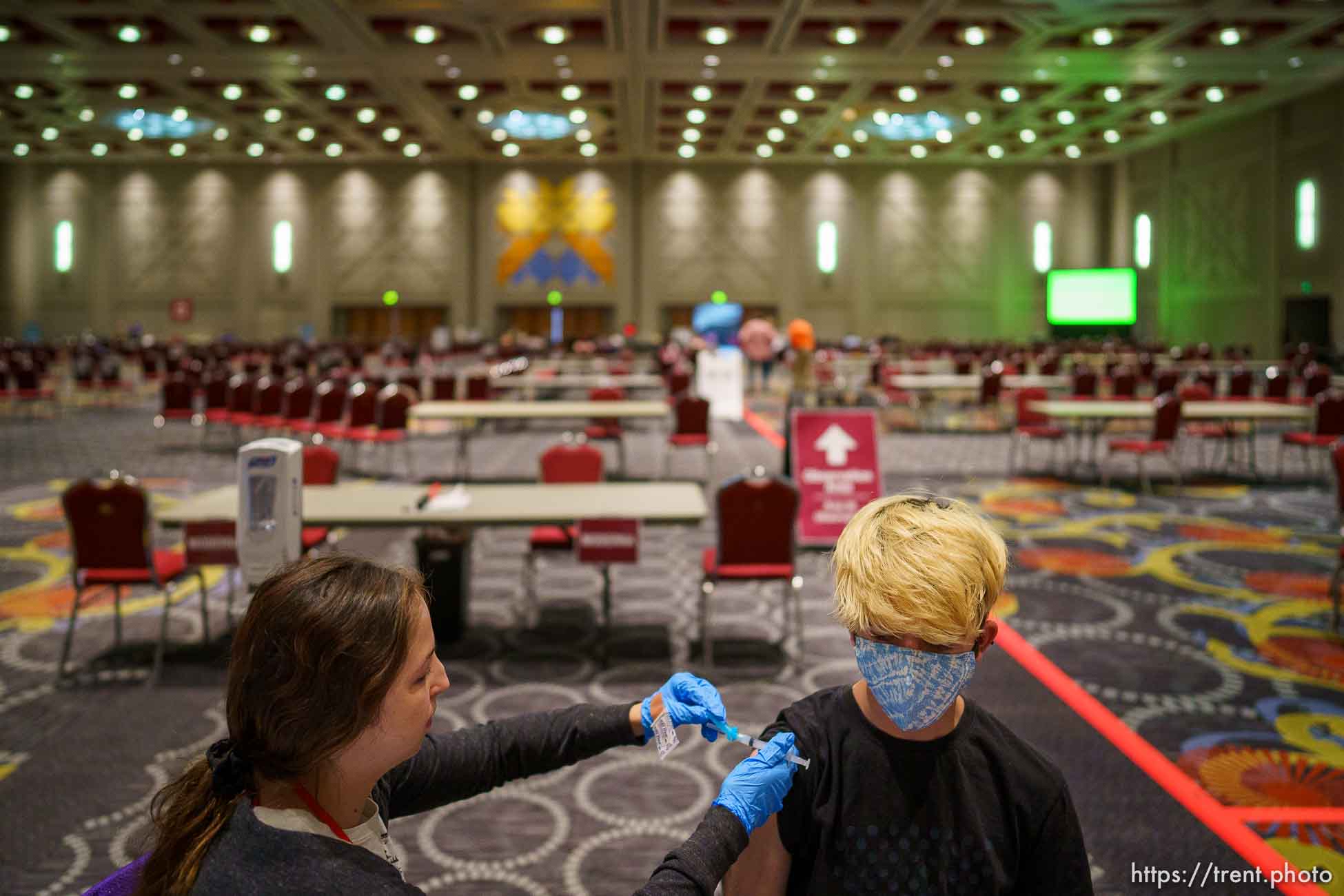 (Trent Nelson  |  The Salt Lake Tribune) Taylor Starr vaccinates Matt Cox in the grand ballroom at the Salt Palace Convention Center in Salt Lake City, Saturday, May 29, 2021.