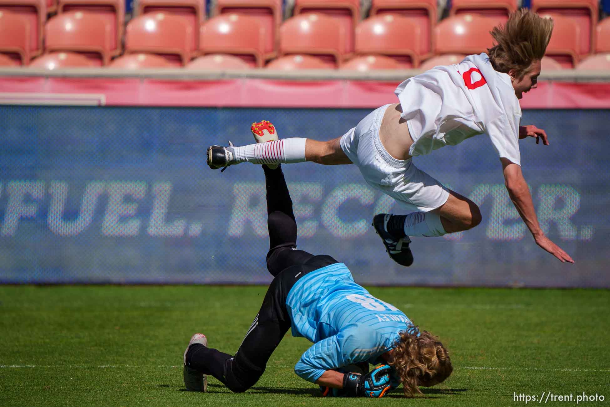 (Trent Nelson  |  The Salt Lake Tribune) Judge Memorial's Evan Nelson flies over Morgan goalkeeper Tanner Stanley in the 3A boys soccer championship, at Rio Tinto Stadium in Sandy on Tuesday, May 18, 2021.