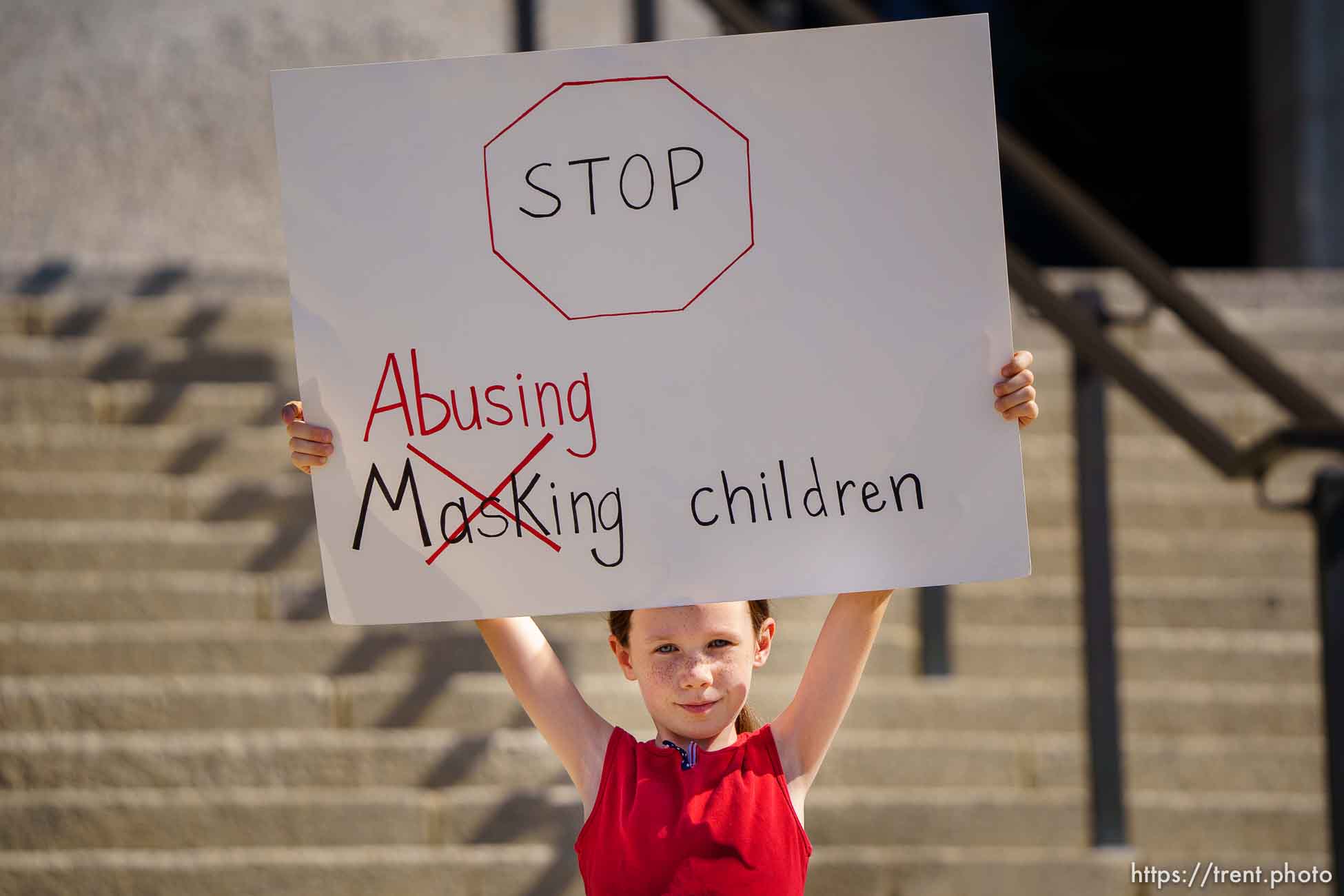 (Trent Nelson  |  The Salt Lake Tribune) A child holds a sign against mask mandates at the State Captiol in Salt Lake City on Wednesday, May 19, 2021.