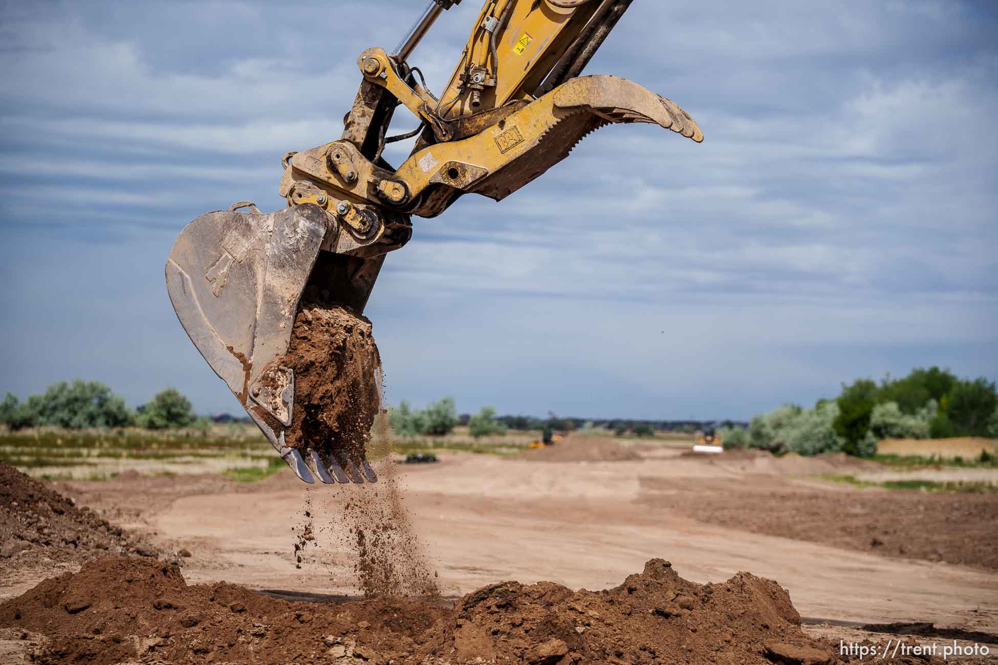 (Trent Nelson  |  The Salt Lake Tribune)  Senate President Stuart Adams, R-Layton, turns dirt with an excavator as UDOT kicks off construction of the West Davis Highway with an event in Layton on Tuesday, May 25, 2021.