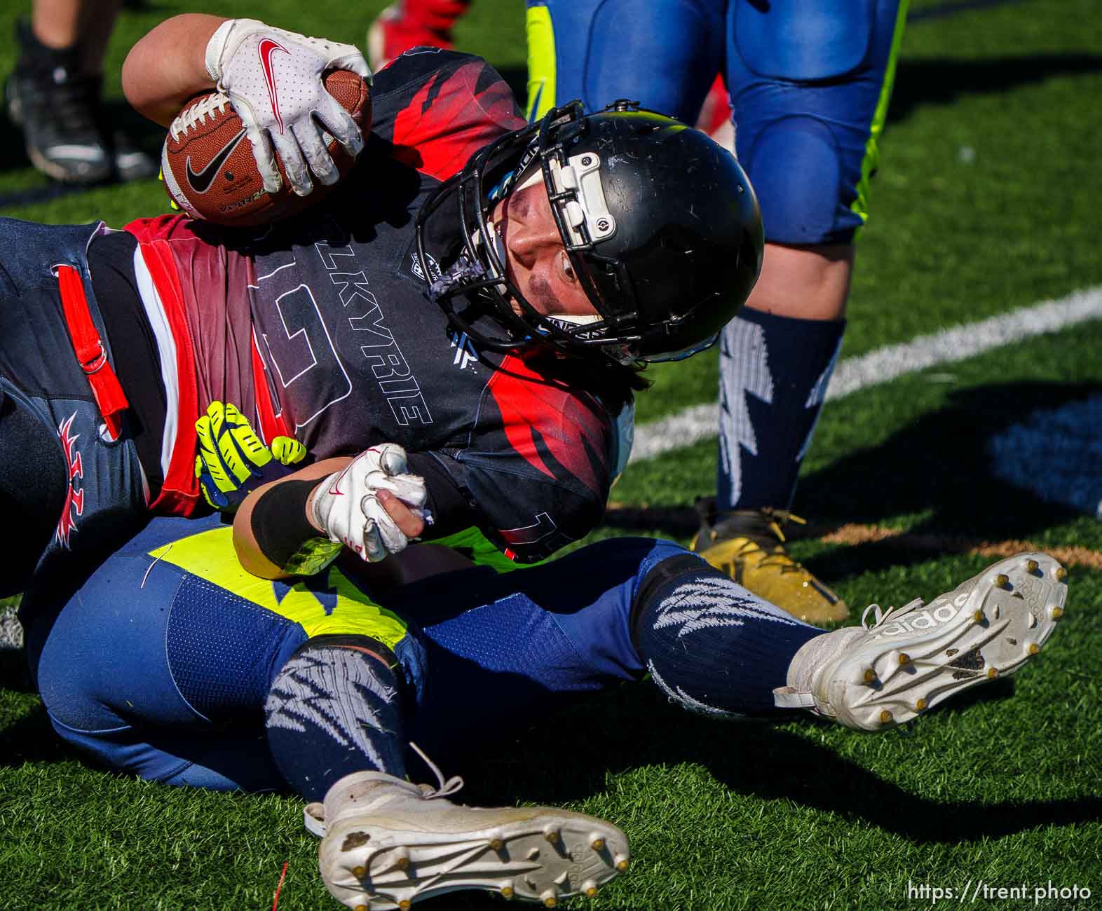 (Trent Nelson  |  The Salt Lake Tribune) Utah Valley's Jadelyn Peterson is tackled by West Jordan's MaryJane Merriam as the Utah Valley Valkyrie face the West Jordan Lightning in the Utah Girls Tackle Football League Division 3 championship game at Herriman High School on Thursday, May 27, 2021.