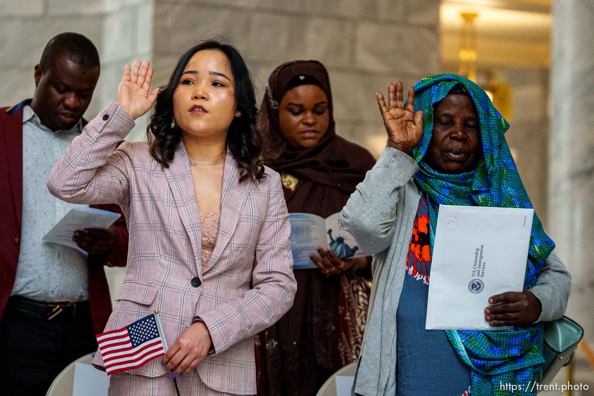 (Trent Nelson  |  The Salt Lake Tribune) From left, Didier Ngendakumana, Mon Tamang, Zainab Masud, and Hawa Gadud take the Oath of Allegiance during a naturalization ceremony as part of Utah’s World Refugee Week celebration, in Salt Lake City on Tuesday, June 15, 2021.