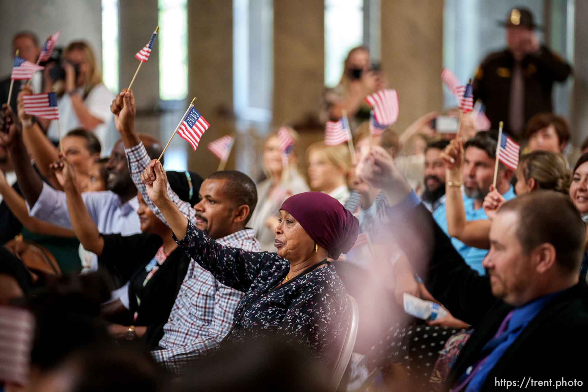 (Trent Nelson  |  The Salt Lake Tribune) Flags are waved to recognize fourteen new citizens at a naturalization ceremony that was part of Utah’s World Refugee Week celebration, in Salt Lake City on Tuesday, June 15, 2021.