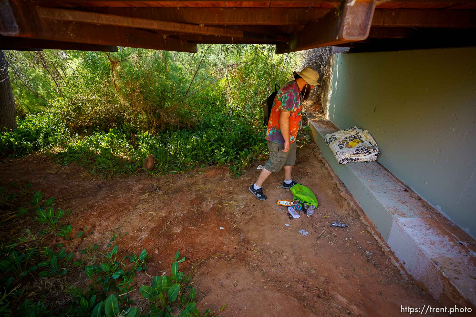 (Trent Nelson  |  The Salt Lake Tribune) Skyler Marshall looks over belongings left by a youth experiencing homelessness in Royal Oaks Park in St. George on Friday, June 11, 2021. Marshall is the street outreach case manager for the nonprofit Youth Futures.