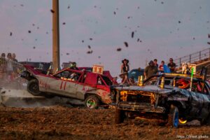 (Trent Nelson  |  The Salt Lake Tribune) Riley Johnson's car is knocked onto the wall during Punishment at the Peak, a demolition derby in Grantsville on Saturday, Aug. 7, 2021.