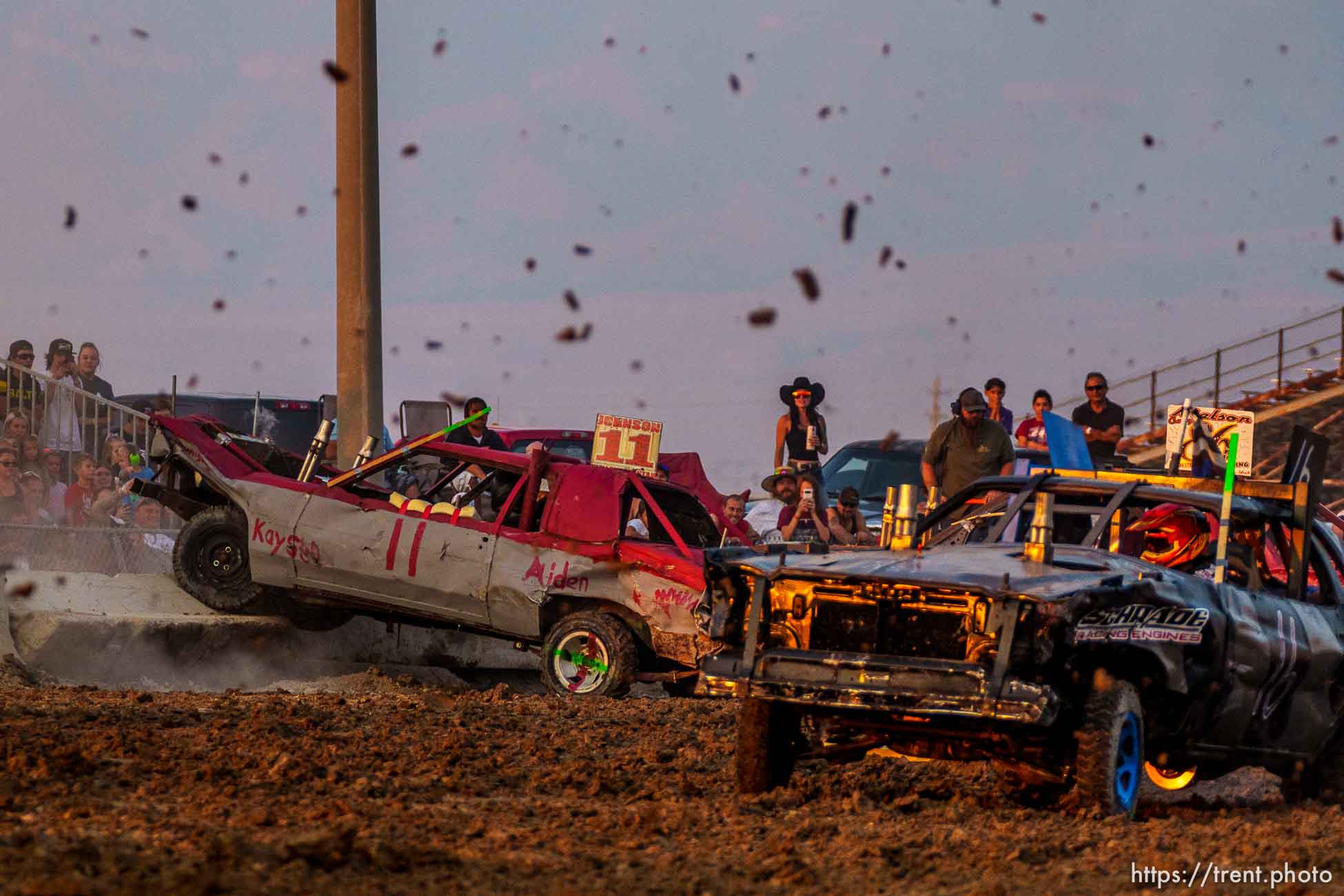 (Trent Nelson  |  The Salt Lake Tribune) Riley Johnson's car is knocked onto the wall during Punishment at the Peak, a demolition derby in Grantsville on Saturday, Aug. 7, 2021.