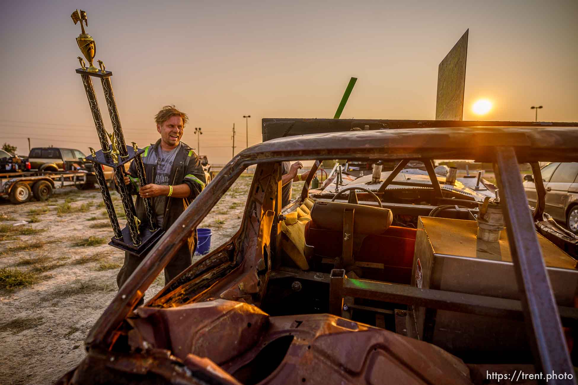 (Trent Nelson  |  The Salt Lake Tribune) Randy Makowsky of Alaska holds his first place trophy in the stock competition at Punishment at the Peak, a demolition derby in Grantsville on Saturday, Aug. 7, 2021.