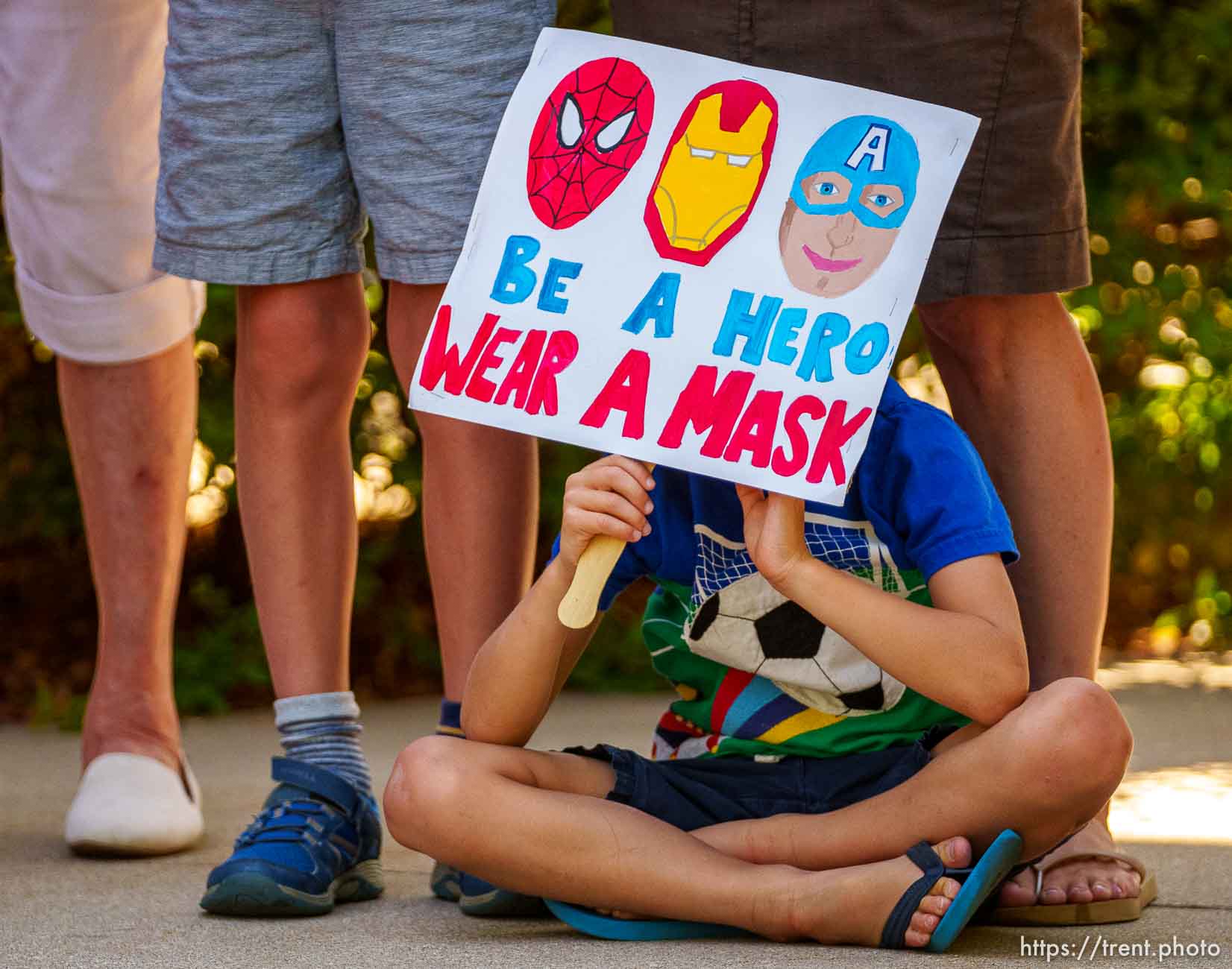 (Trent Nelson  |  The Salt Lake Tribune) Jack Nazzaro sits at his mother's feet as speakers react to the county's vote against a mask mandate in schools on Thursday, Aug. 12, 2021.