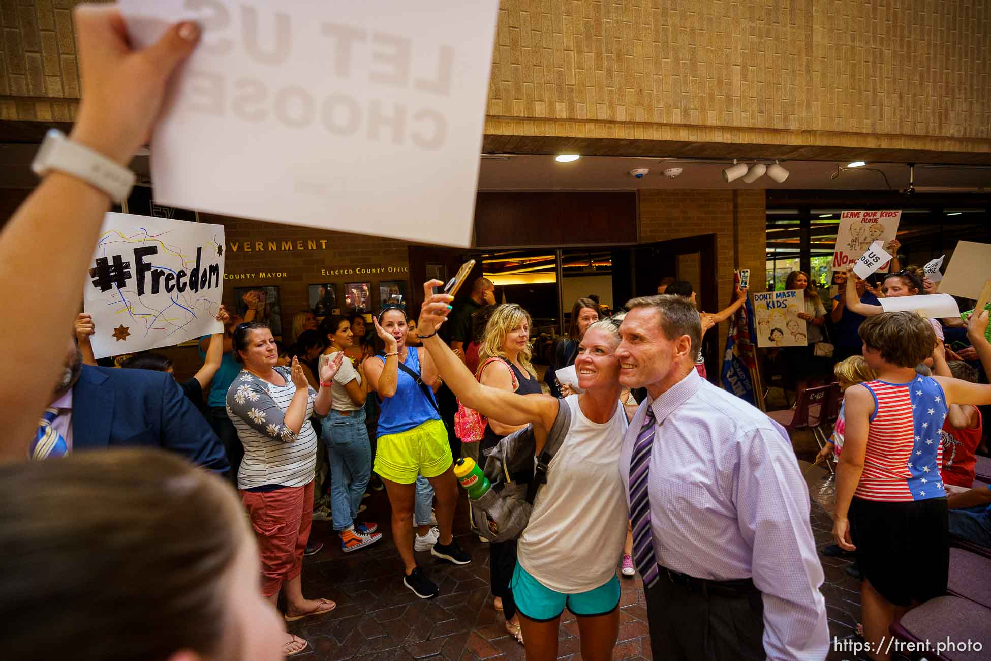 (Trent Nelson  |  The Salt Lake Tribune) Anti-mask mandate crowd celebrates after the Salt Lake County Council voted down Dr. Angela Dunn's mask ordinance for K-6 students, on Thursday, Aug. 12, 2021. Steve DeBry, Chair of the council, interacts.