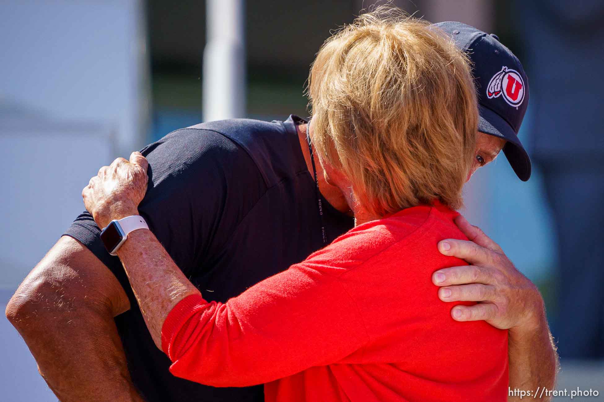 (Trent Nelson  |  The Salt Lake Tribune) Football coach Kyle Whittingham embraces Kathi Garff as the Ken Garff Red Zone at Rice-Eccles Stadium in Salt Lake City is officially unveiled in a ribbon-cutting ceremony on Thursday, Aug. 12, 2021.