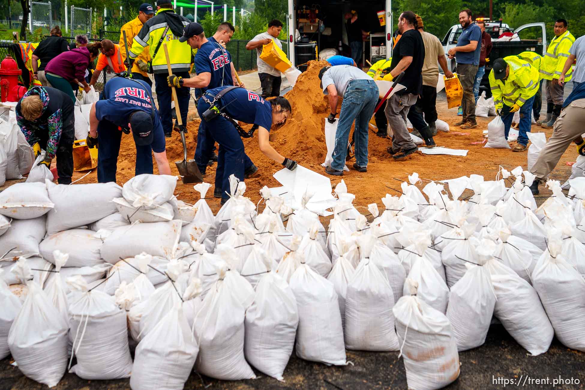 (Trent Nelson  |  The Salt Lake Tribune) Firefighters, public works employees, and volunteers fill sandbags in South Salt Lake after heavy rains on Wednesday, Aug. 18, 2021.