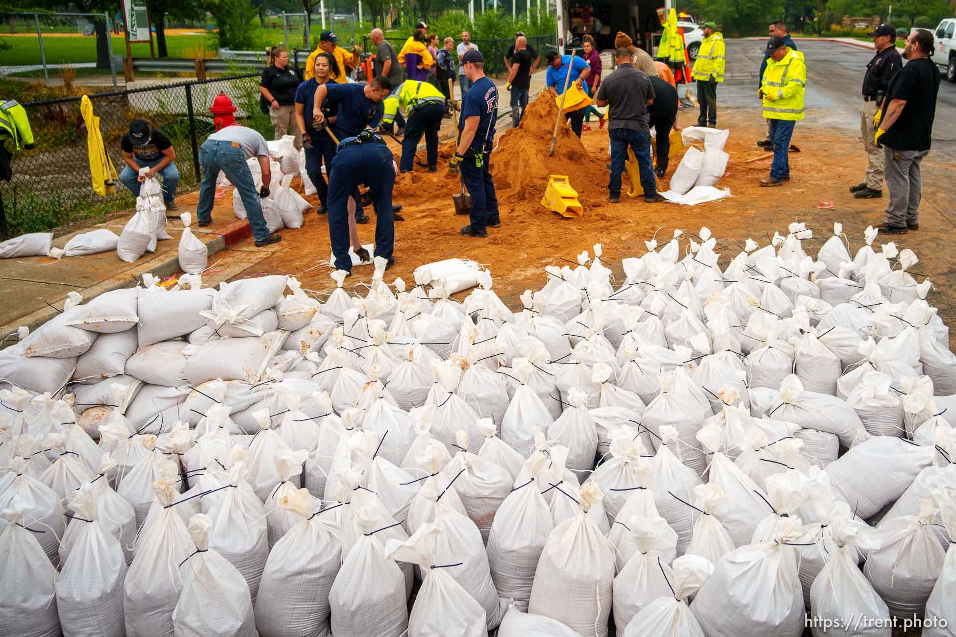 (Trent Nelson  |  The Salt Lake Tribune) Firefighters, public works employees, and volunteers fill sandbags in South Salt Lake after heavy rains on Wednesday, Aug. 18, 2021.