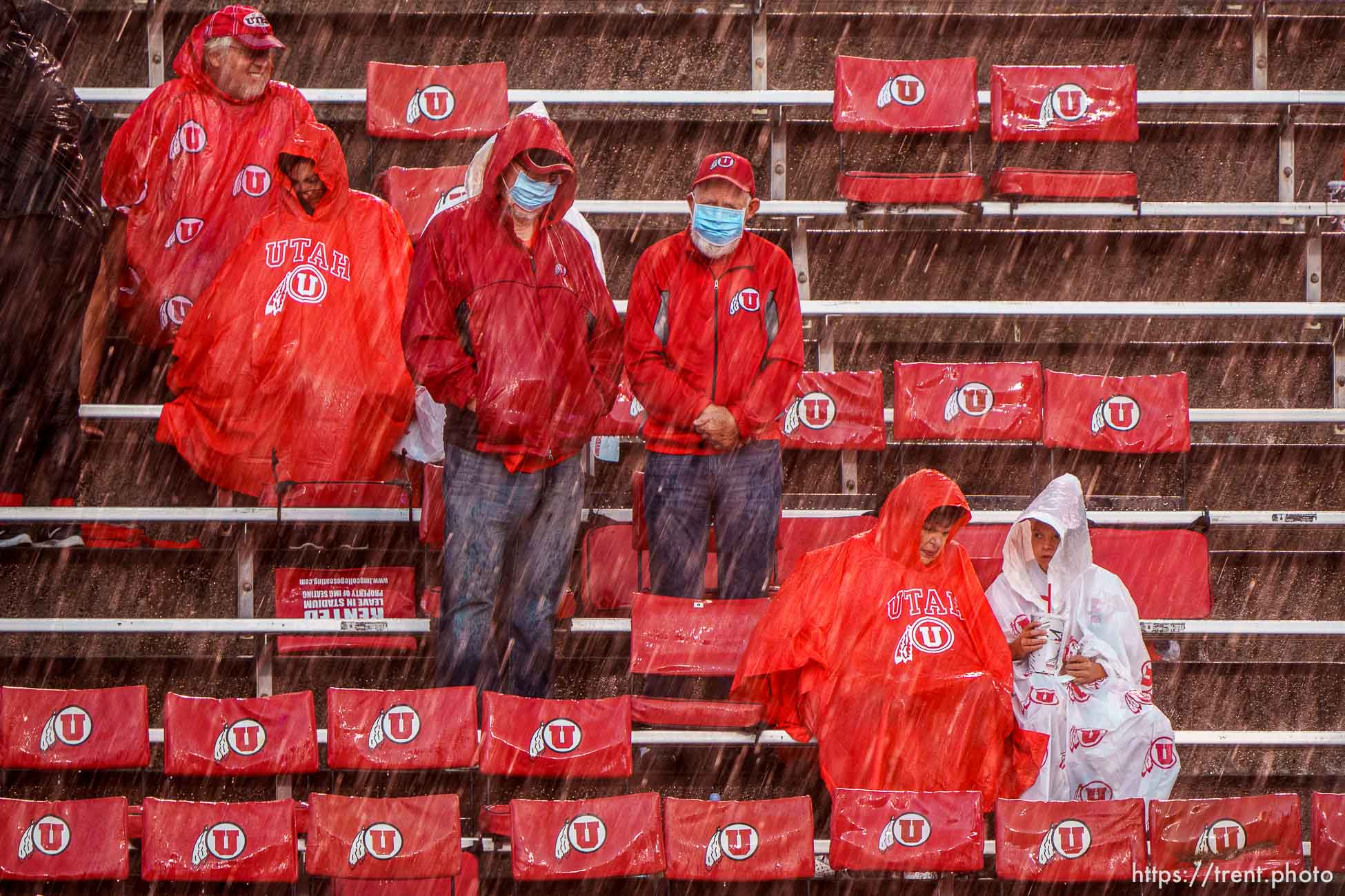 (Trent Nelson  |  The Salt Lake Tribune) Rain pours down on fans during a lightning delay as the Utah Utes host the Weber State Wildcats in Salt Lake City on Thursday, Sept. 2, 2021.